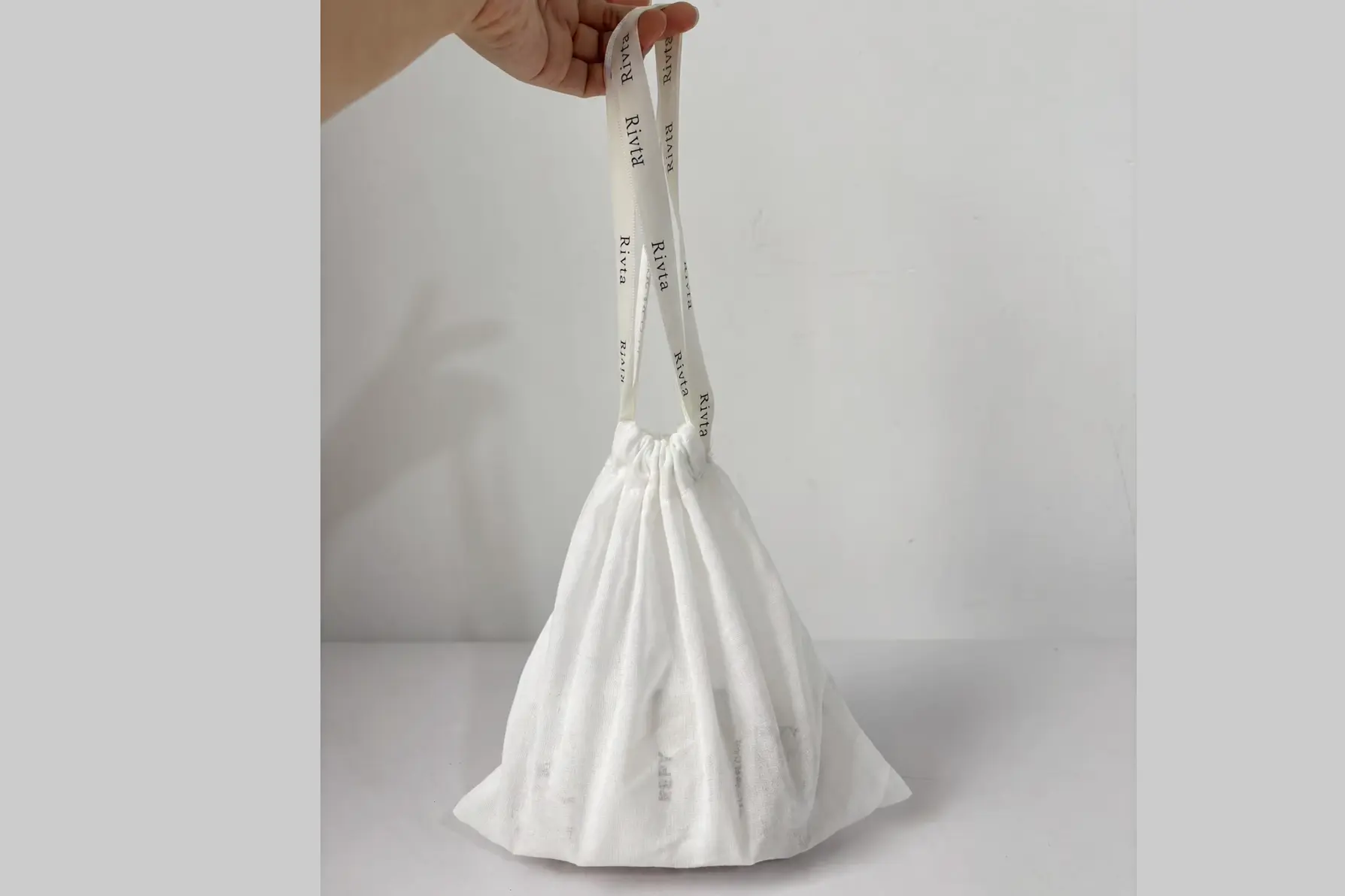 G9868 public display version of cotton mesh drawstring pouch with Rivta ribbon branding