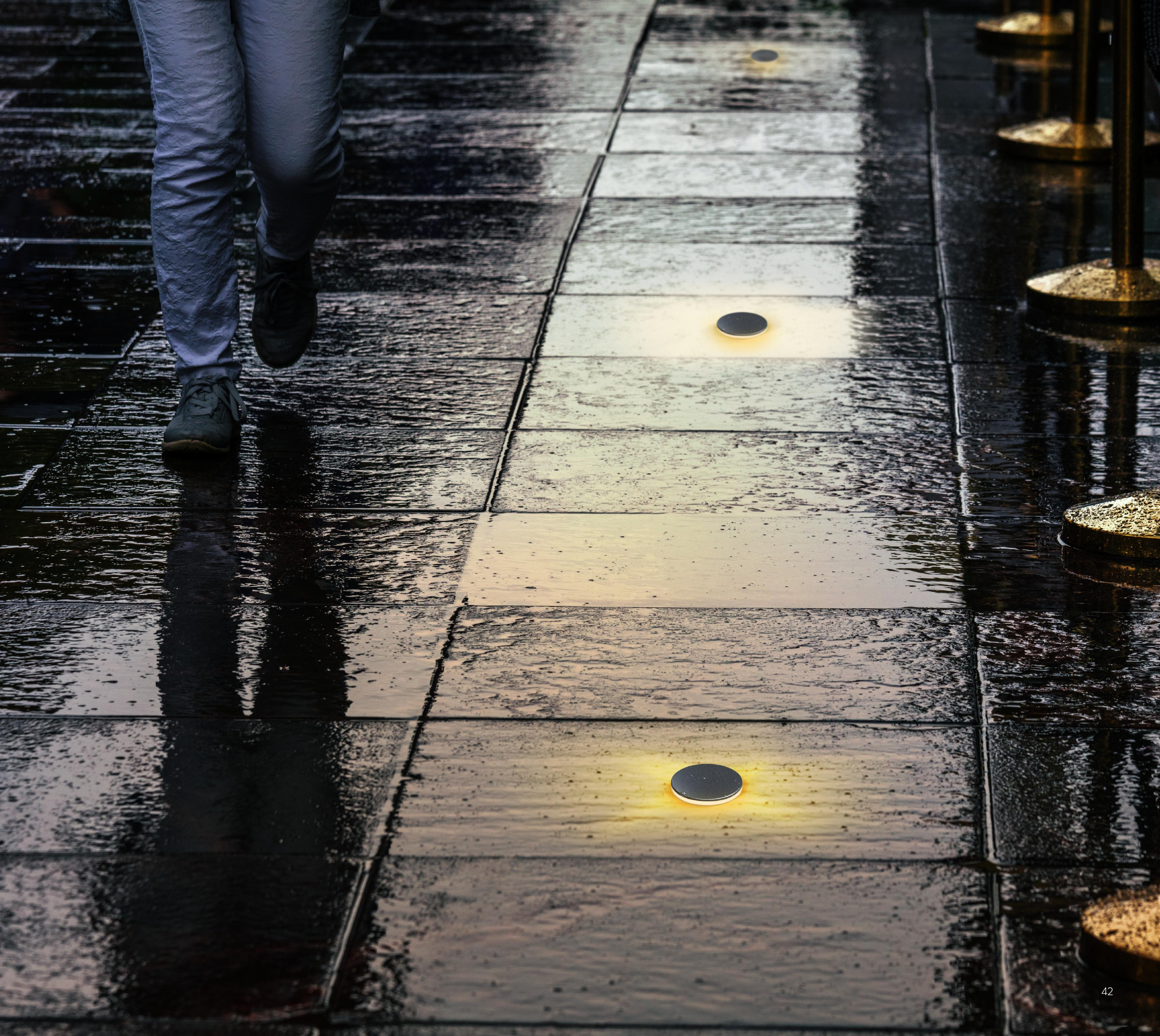 Original catalogue walk-over lighting scene on an outdoor paved path