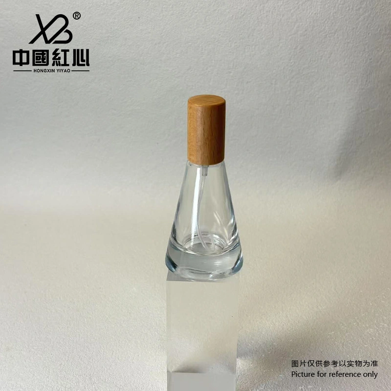 Transparent conical glass bottle with black spray head for perfume filling