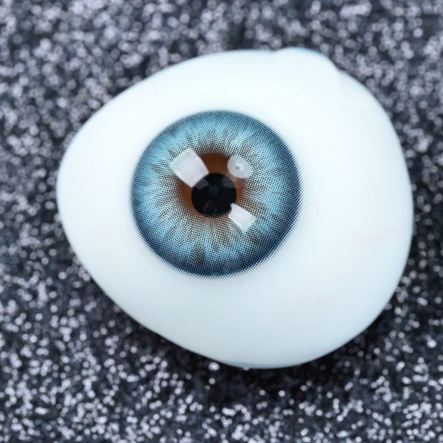 Nebula Gray colored contact lens design with cool gray and blue-teal swirls