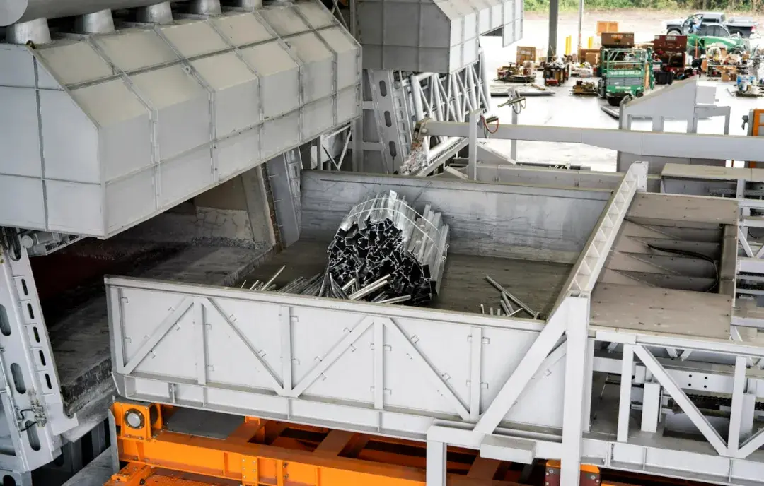 The charging machine evenly distributes the waste material into the furnace.