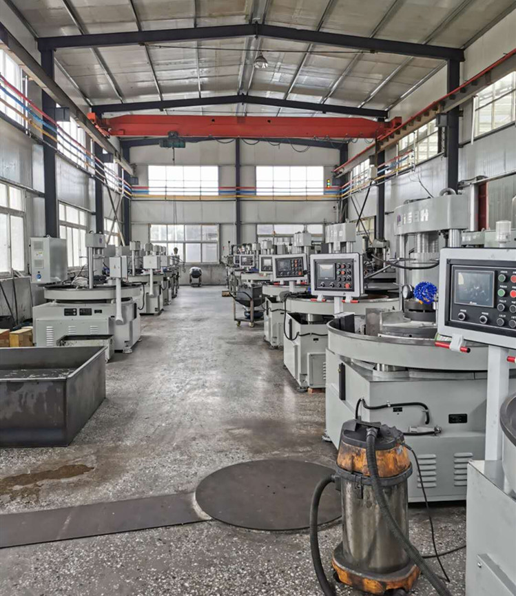 Manufacturing workshop with rows of industrial grinding and polishing machines