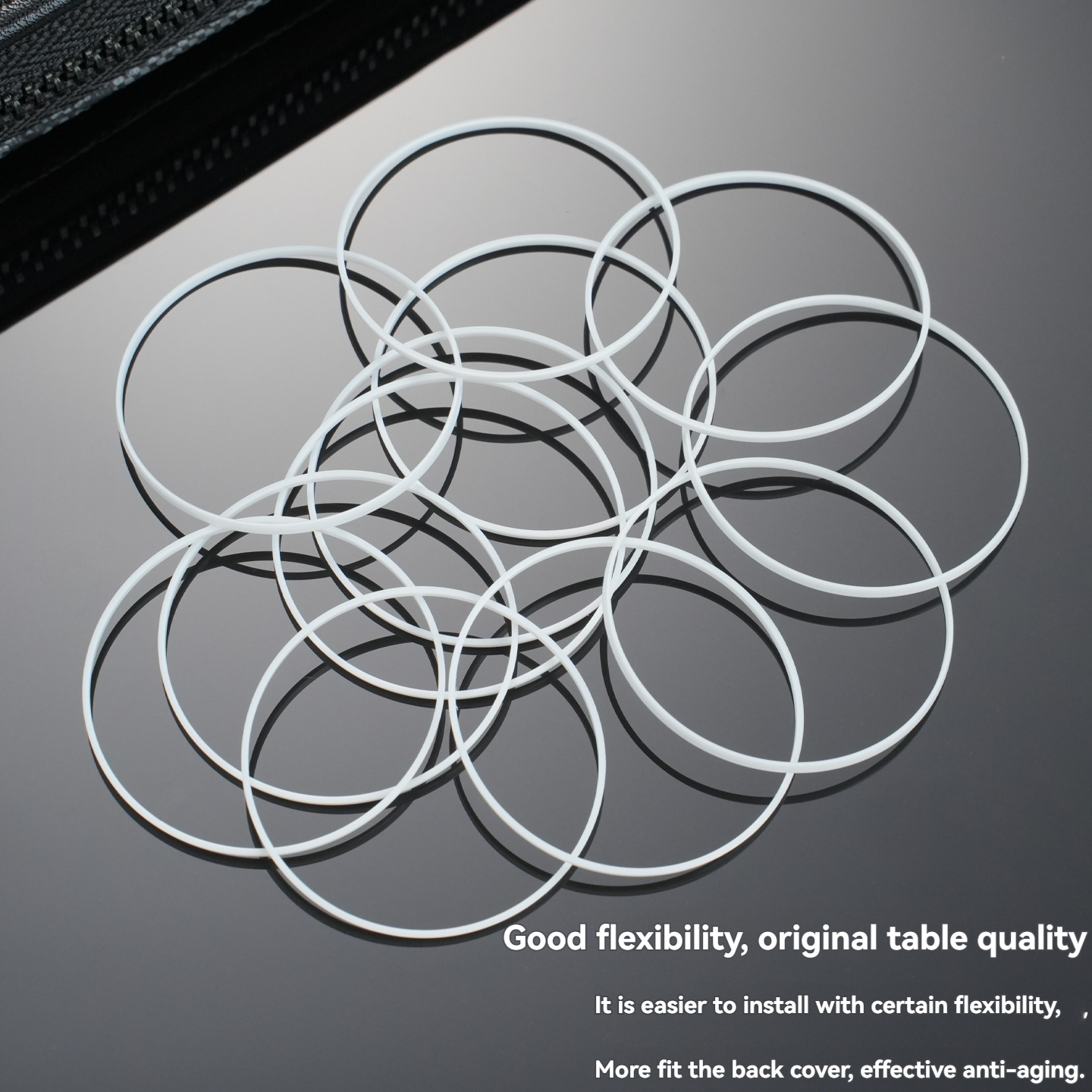 Pile of white gasket rings on dark glossy surface