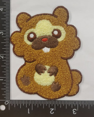 Chenille and embroidery bear - shaped patch, approximately 4 inches tall. The design features a light beige face with brown circular eyes, a brown nose, a small red mouth and a white snout area. The bear’s body is a soft light brown, while the ears, paws and paw pads are dark brown with Chenille texture. Embroidery details outline the bear’s shape, and a ruler in the background indicates its size. The patch combines fluffy Chenille and precise embroidery for a cute, tactile look.