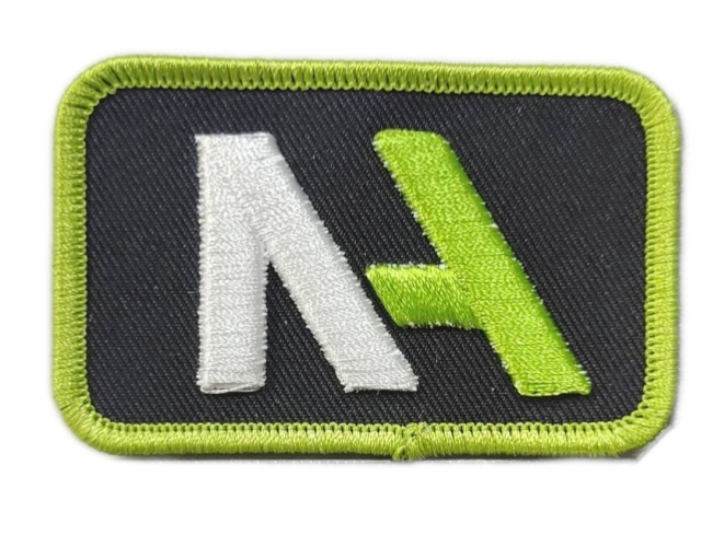 3D Embroidered "NA" Logo Patch - Merrow Border Iron-On Backing