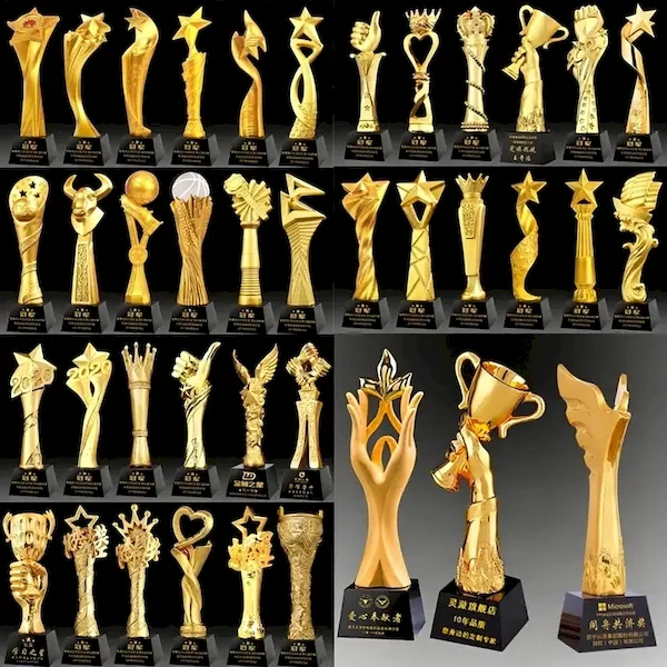 Large variety of gold resin trophies including stars, cups, wings, and abstract figures on black bases for wholesale.
