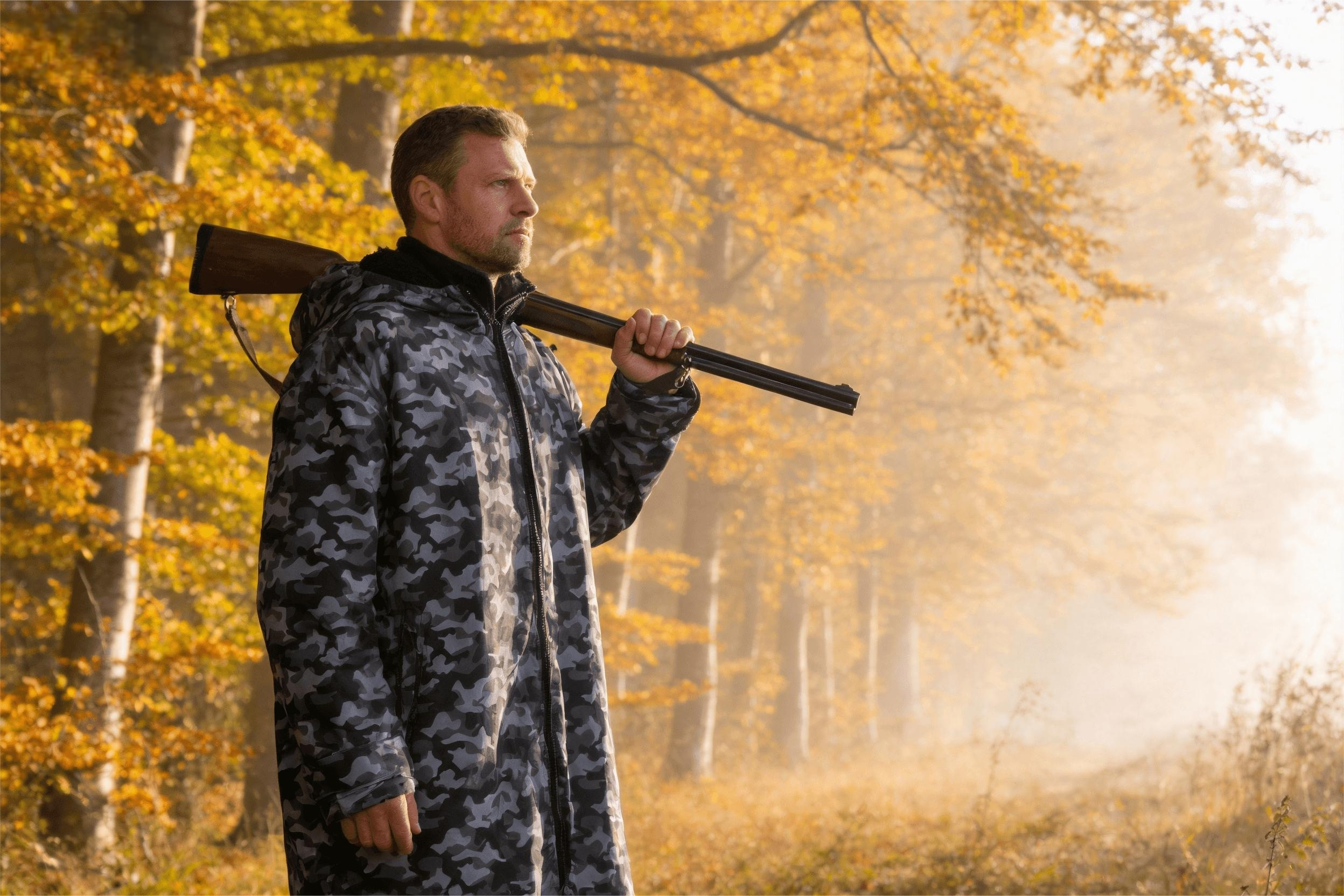 Hunter wearing camo changing robe in forest