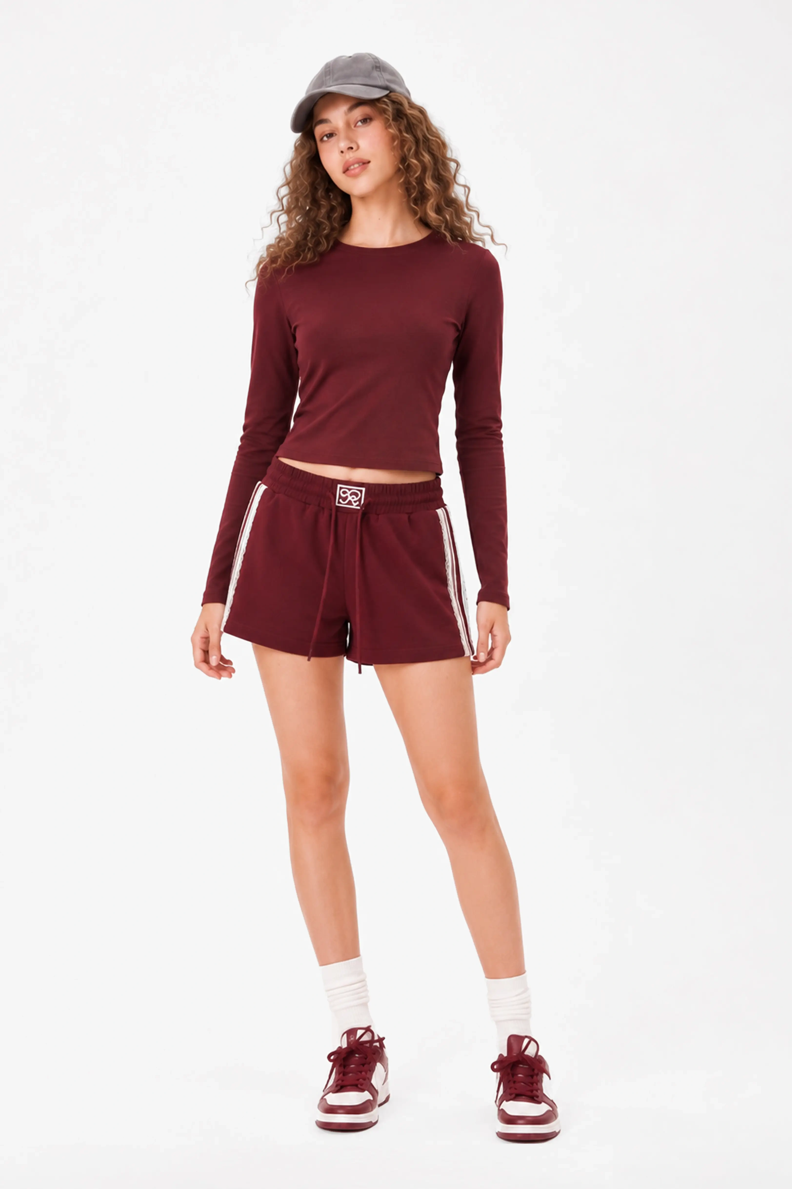 Woman wearing burgundy lace trim cotton sweat shorts showing relaxed fit and sporty style