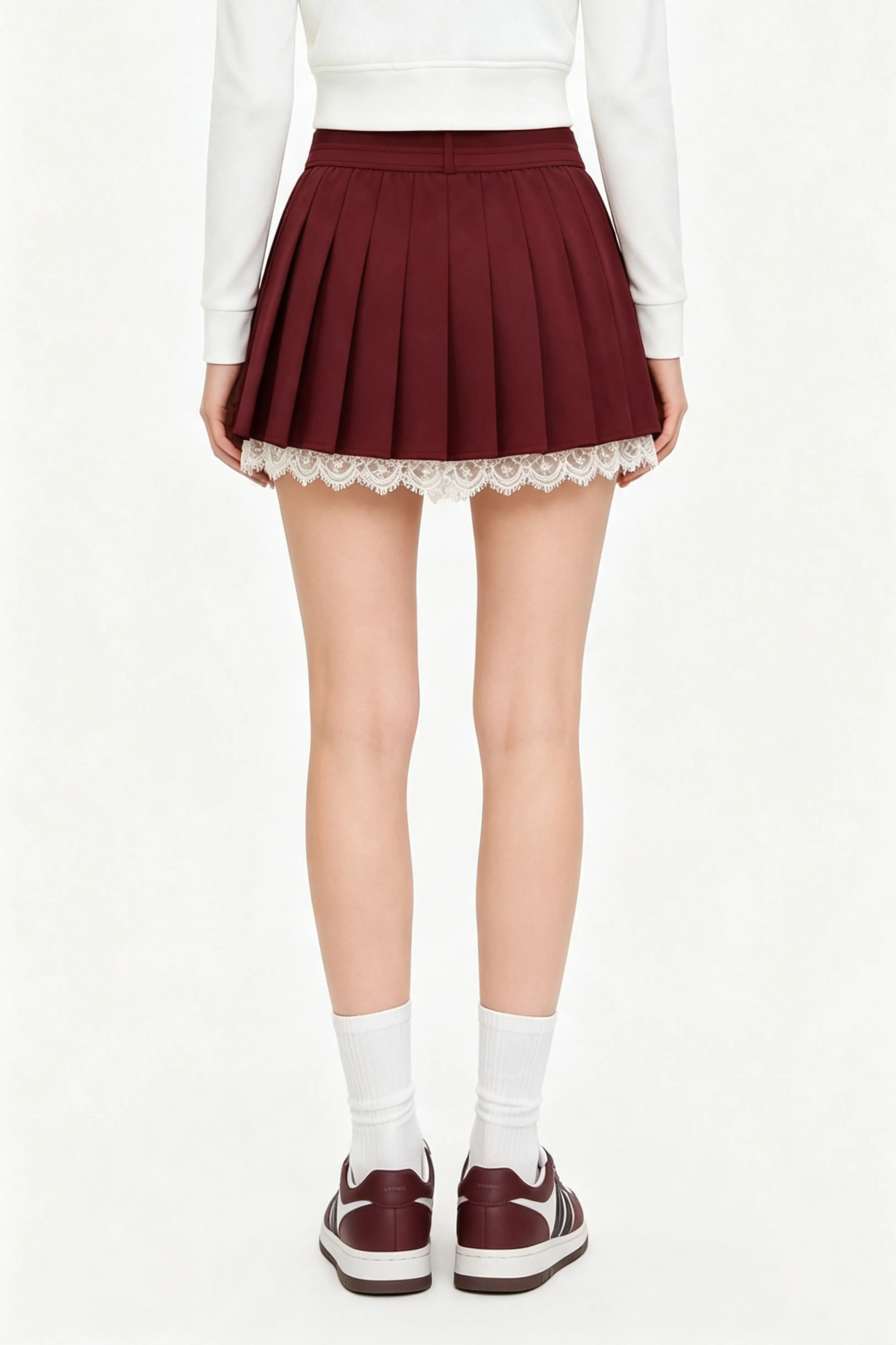 Back view of a high waisted burgundy tennis skirt with pleated design and lovely lace trim detailing.