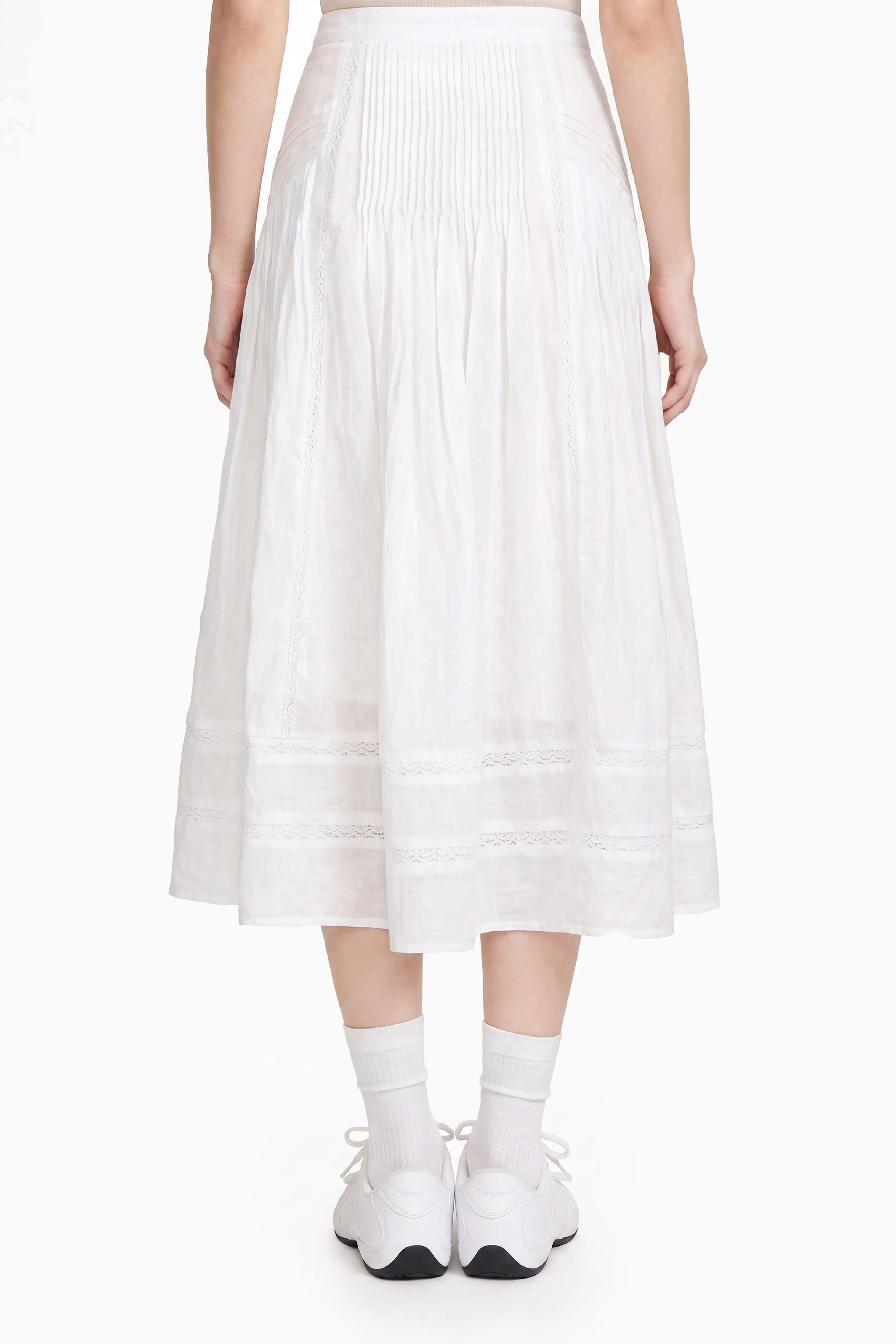 Front view of a white midi skirt featuring a high-waisted pleated upper band and tiered flowy lower hem.