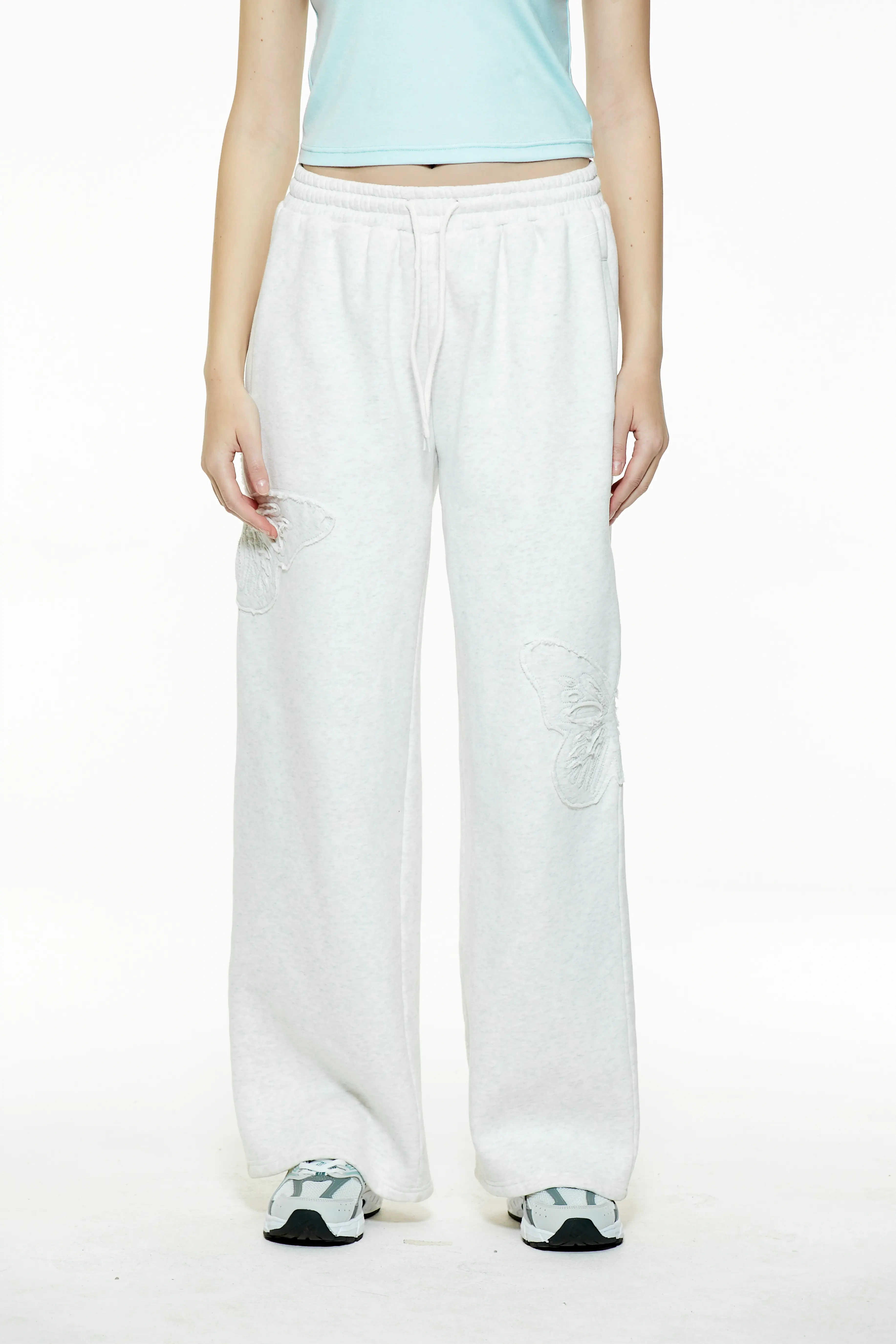 Front view of high-waisted heather grey butterfly sweatpants with a drawstring elastic waist and wide-leg fit.