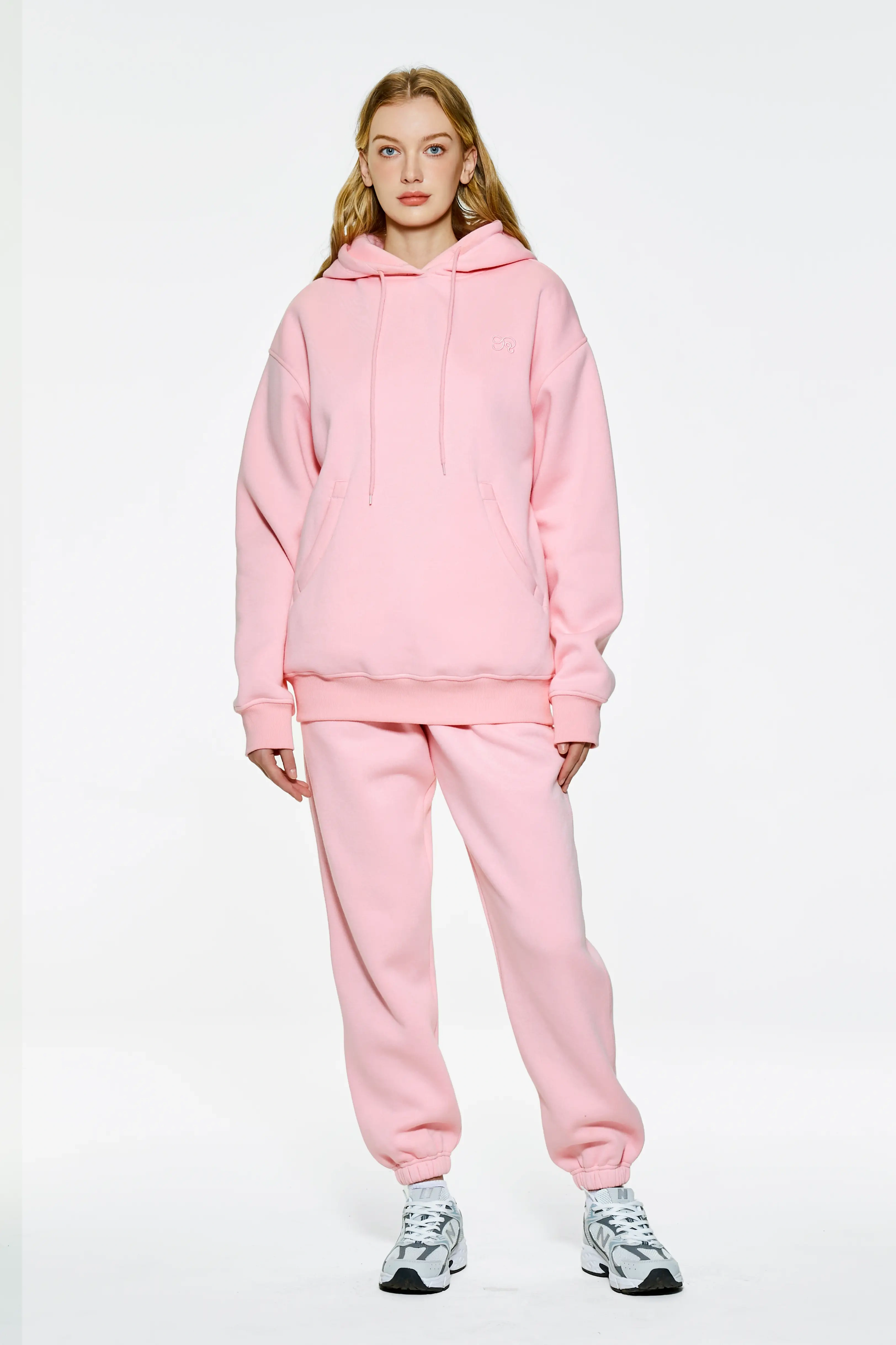 Pink drop shoulder hoodie and matching sweatpants with sneakers