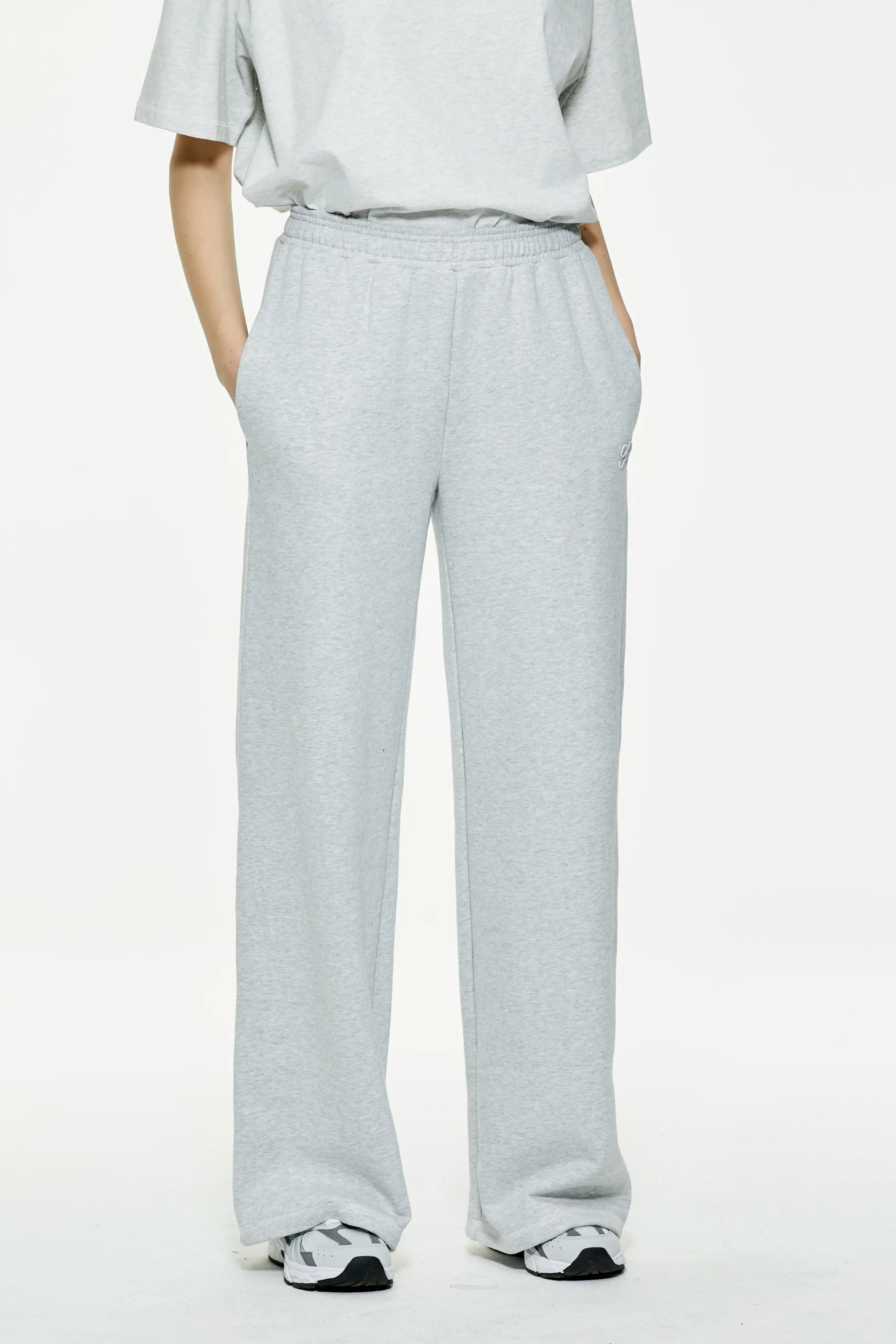 Heather gray wide leg sweatpants featuring high-waisted elastic waistband and side pockets