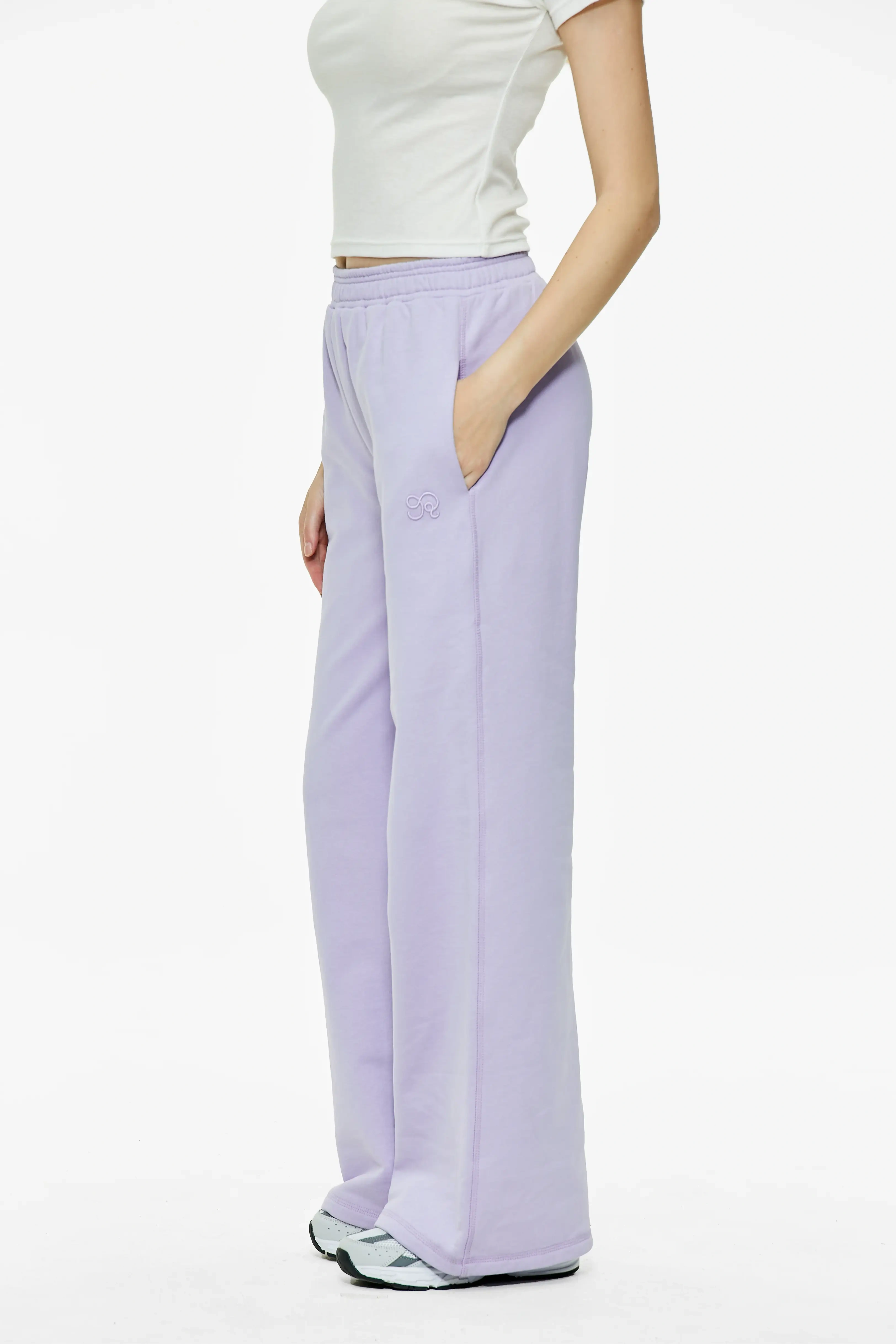 Light purple wide leg sweatpants featuring side pockets and relaxed straight silhouette