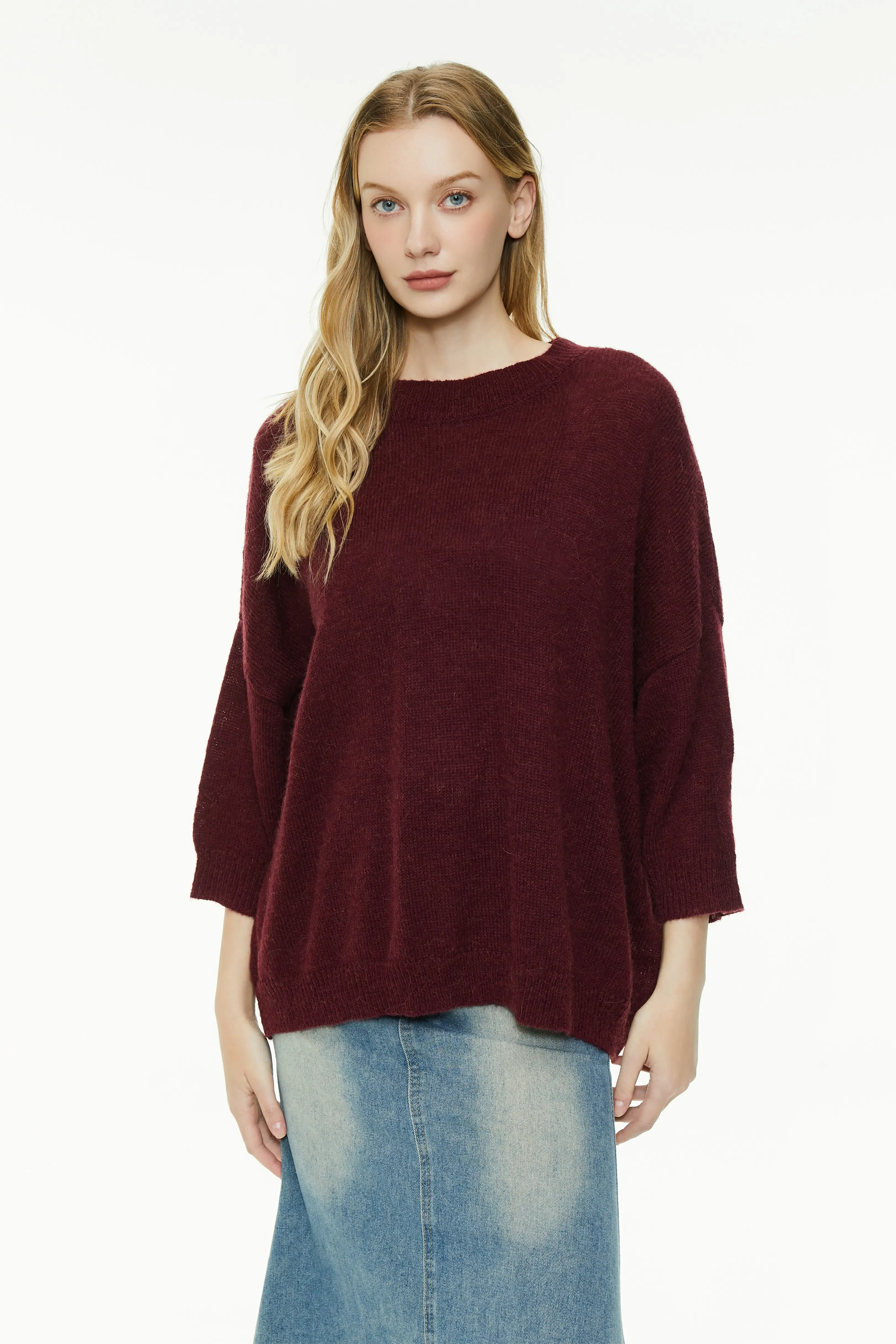 Burgundy knit sweater with a round neck and three-quarter sleeves