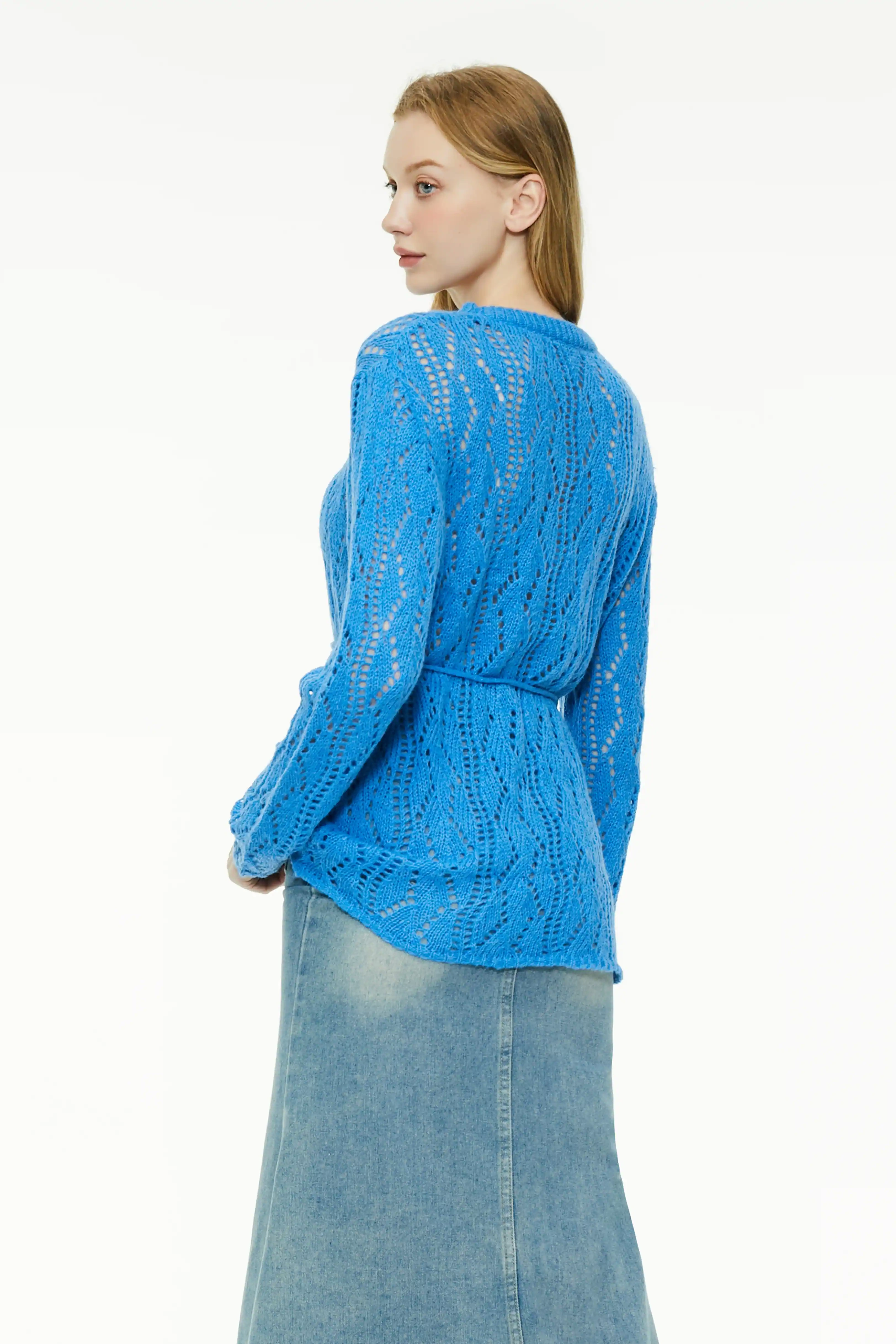 Back view of a blue sheer knit sweater showing a relaxed drape and waist cinching
