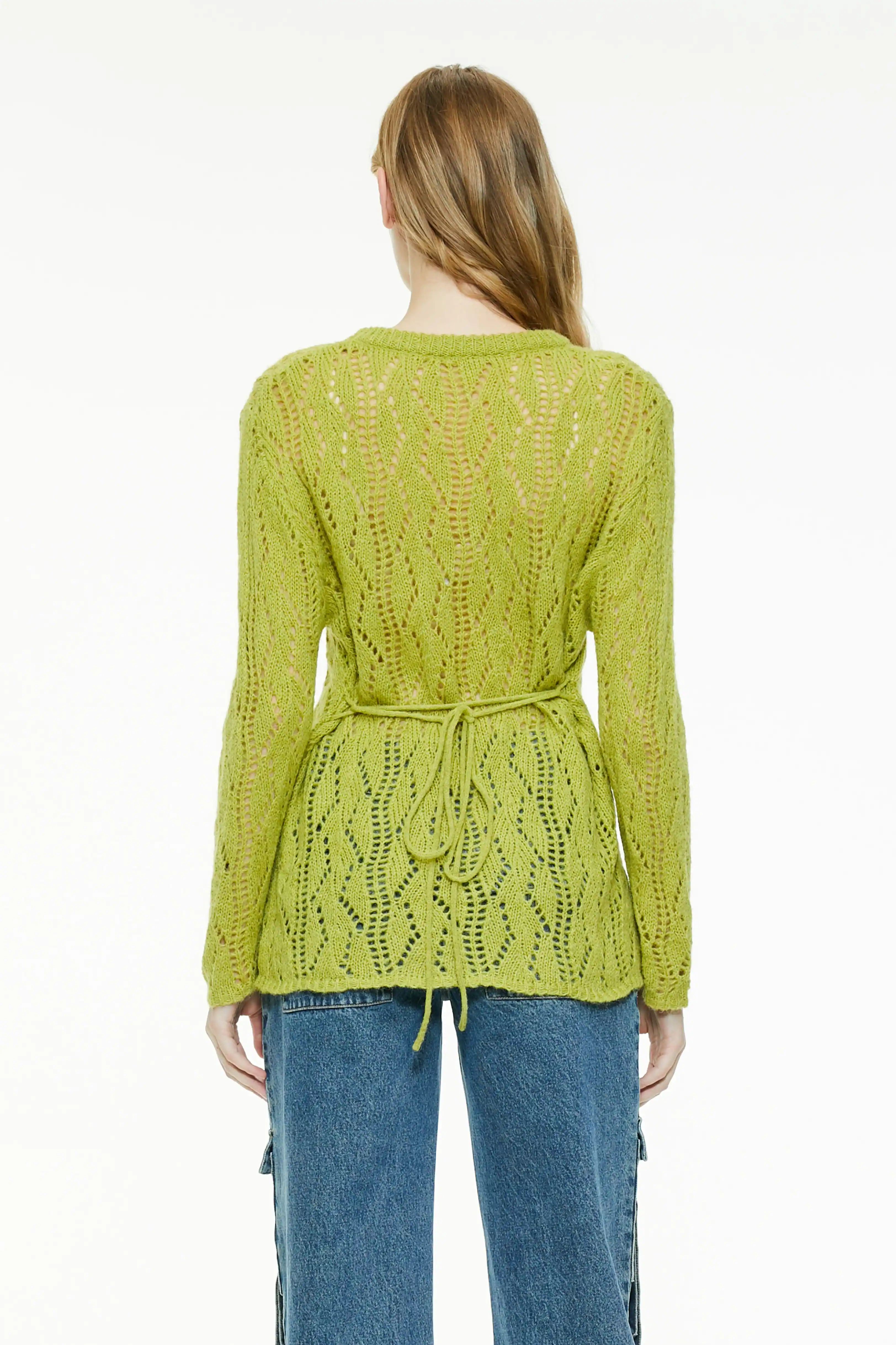 Back view of a chartreuse sheer knit sweater showing the adjustable waist tie