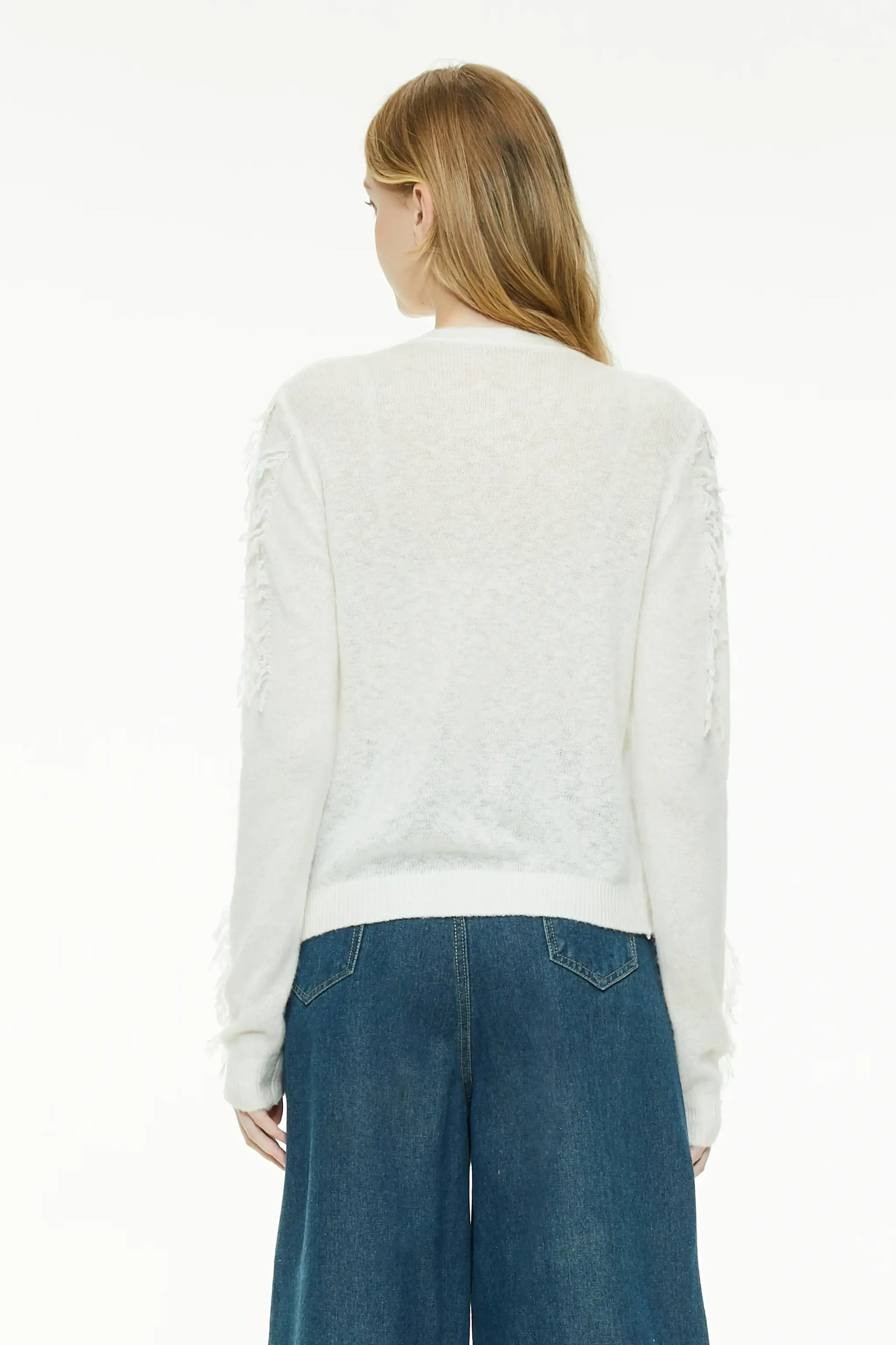 White cardigan showing the clean rear drape and textured knit back design