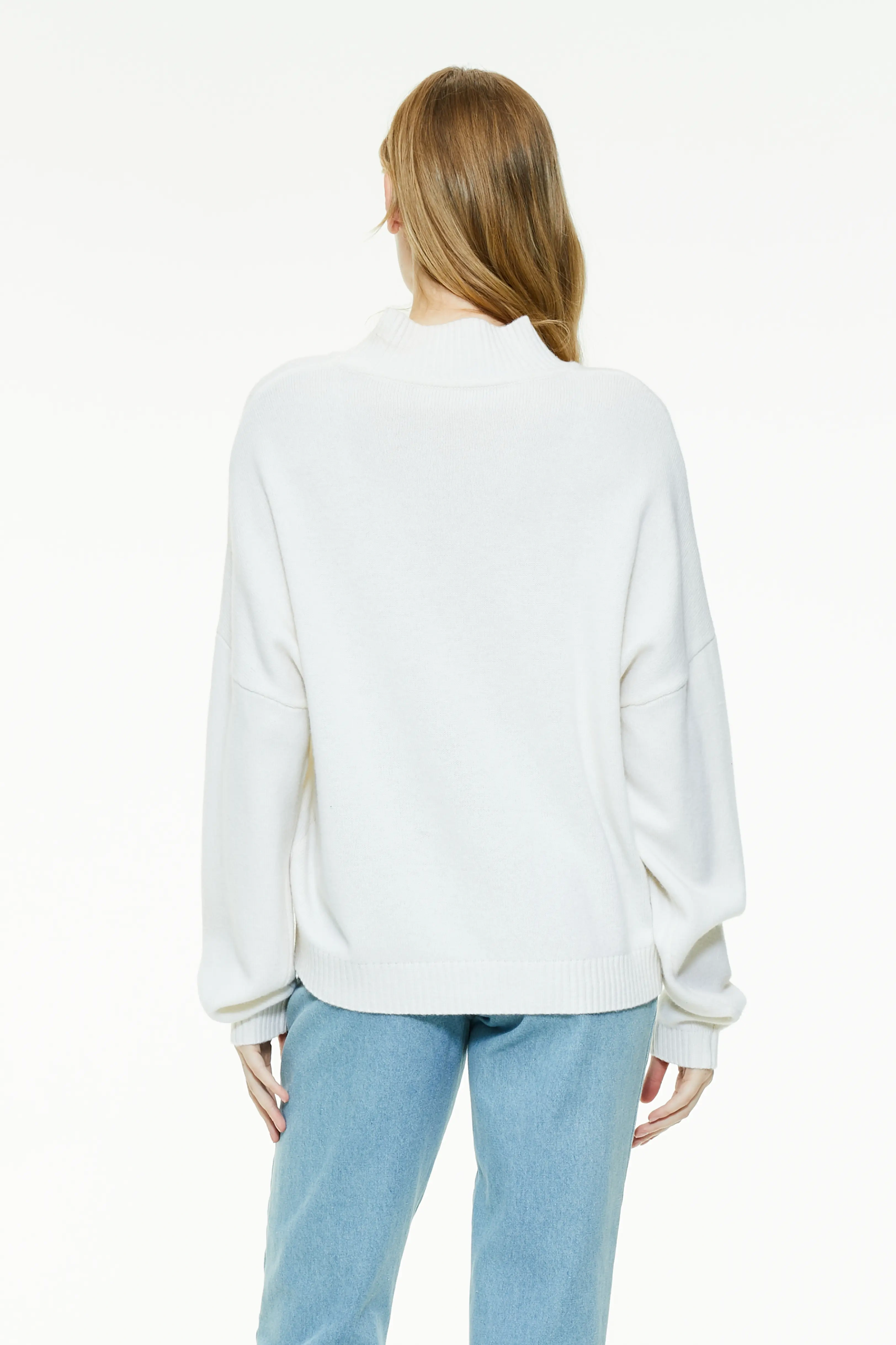 White turtleneck sweater showing a clean rear drape and drop-shoulder silhouette