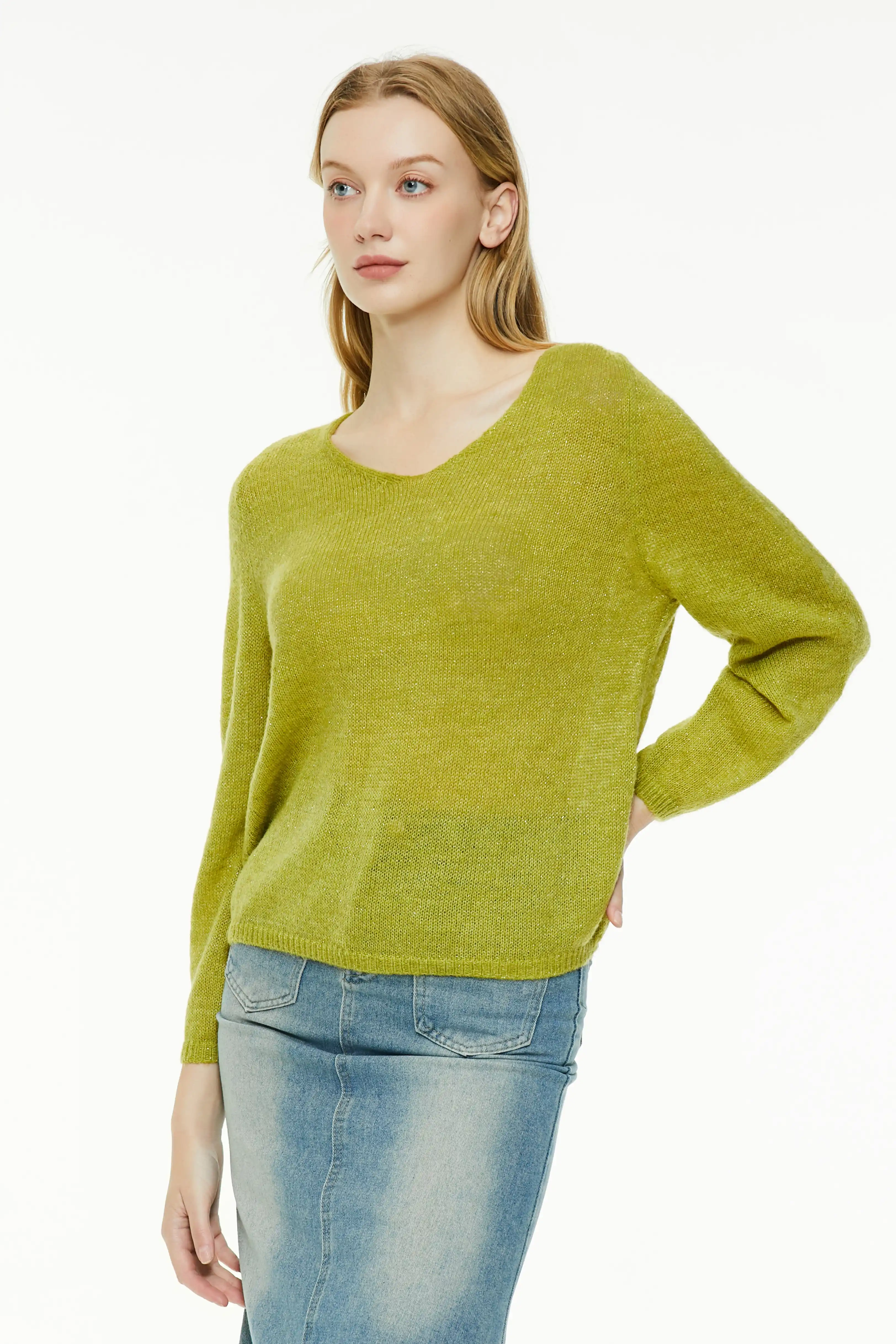 Chartreuse loose knit sweater with a relaxed fit paired with a denim skirt