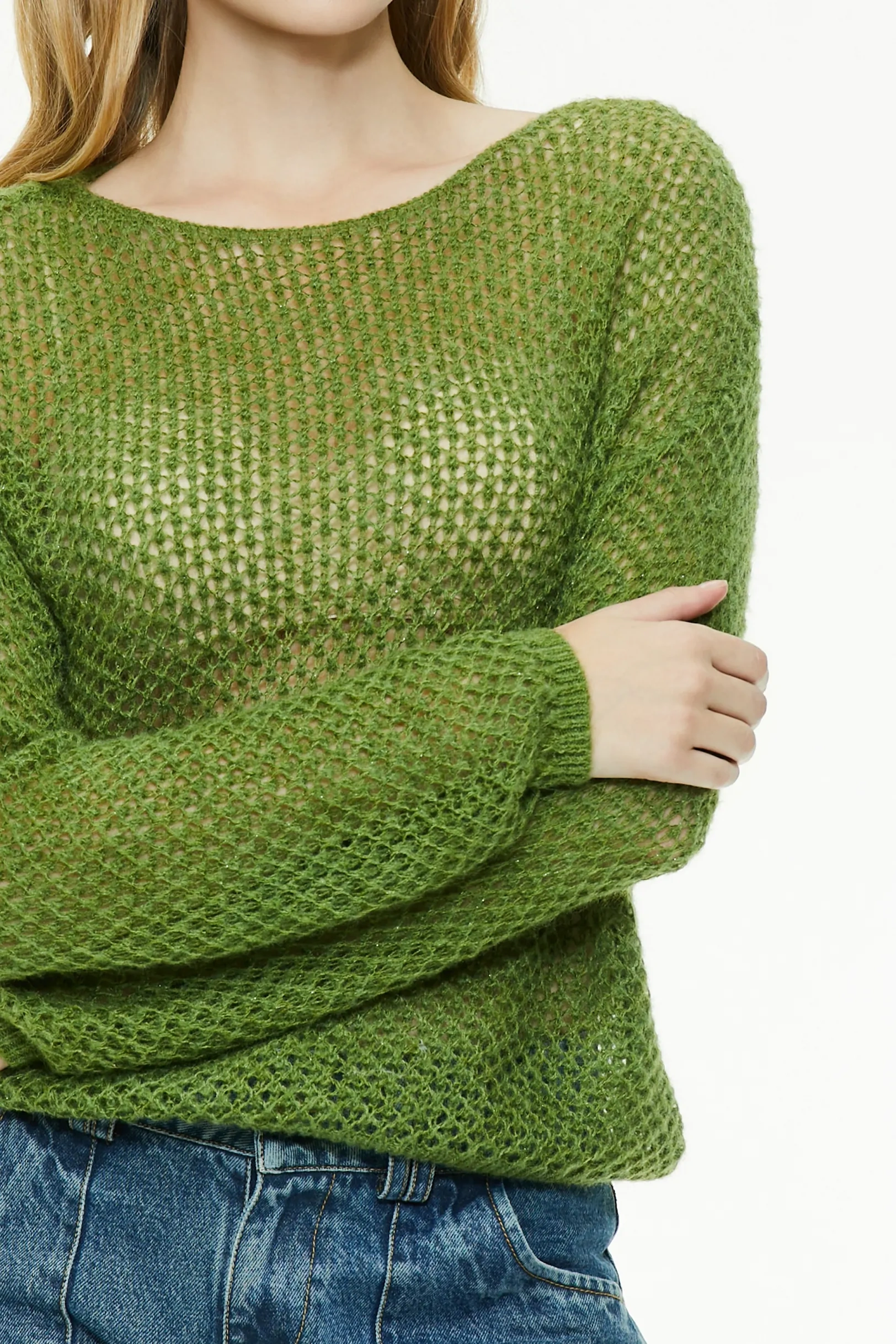 Close-up view of the textured open knit pattern on a green sweater