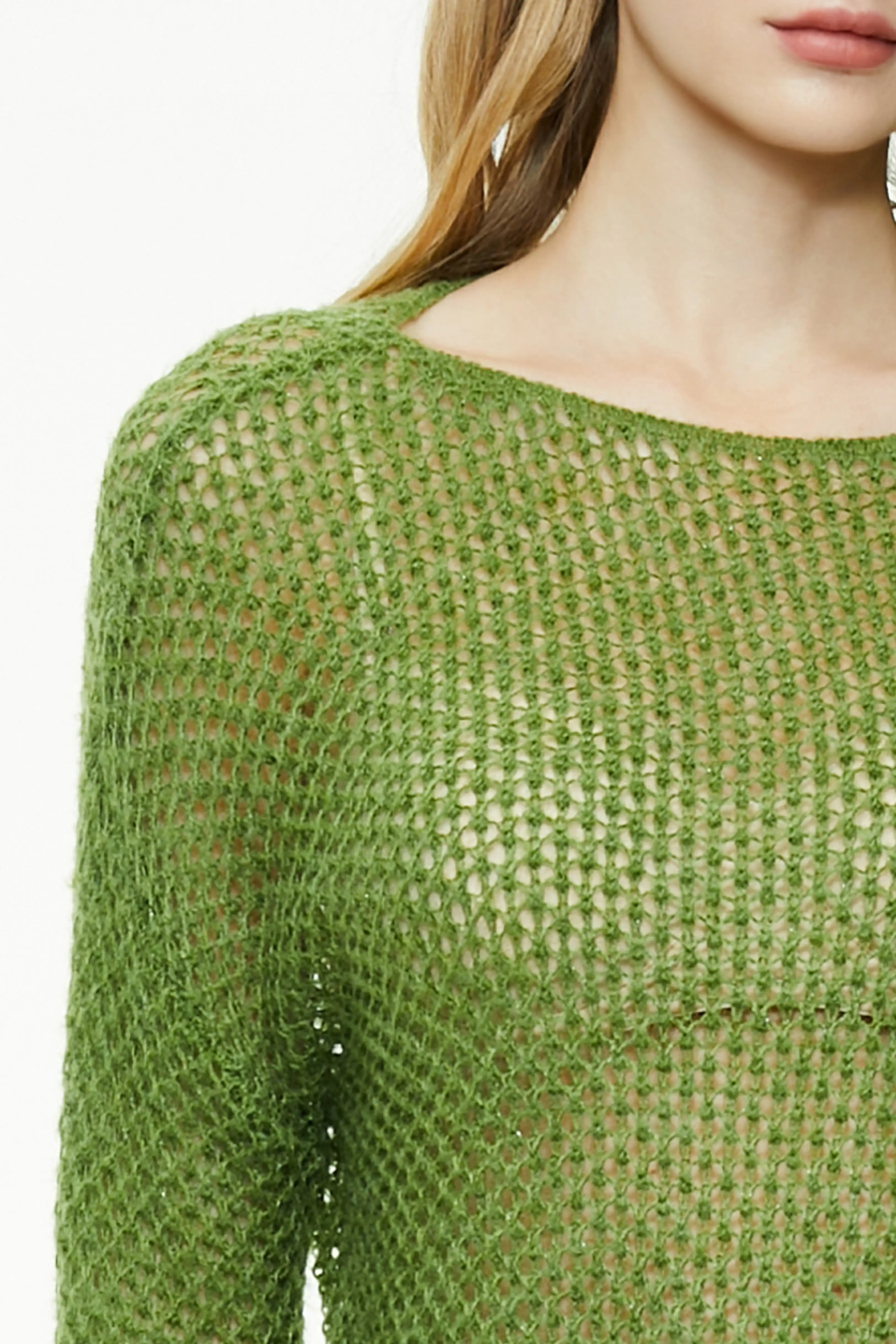 Shoulder and neckline detail of a green open knit sweater