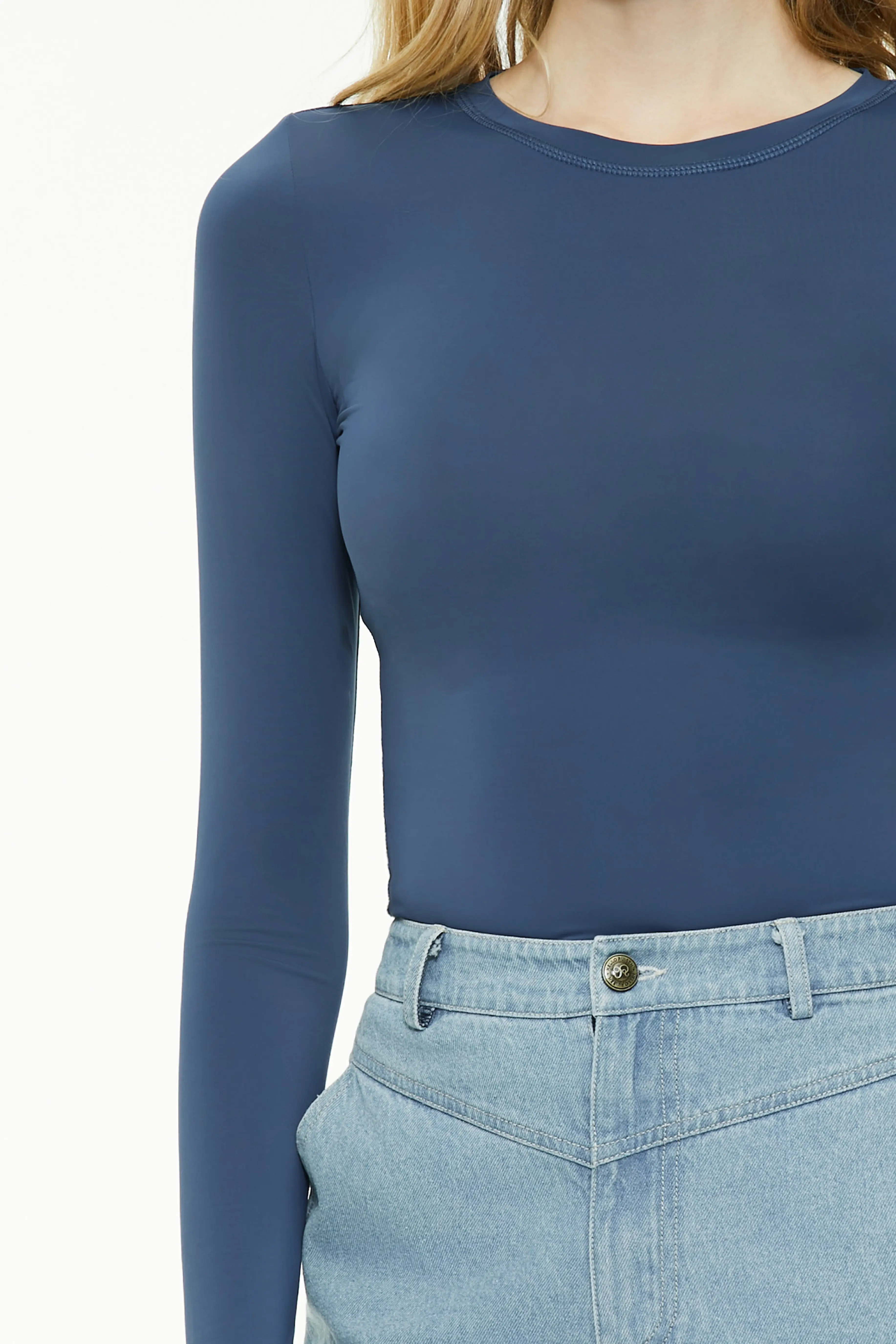 Detailed view of a blue long sleeve fitted top