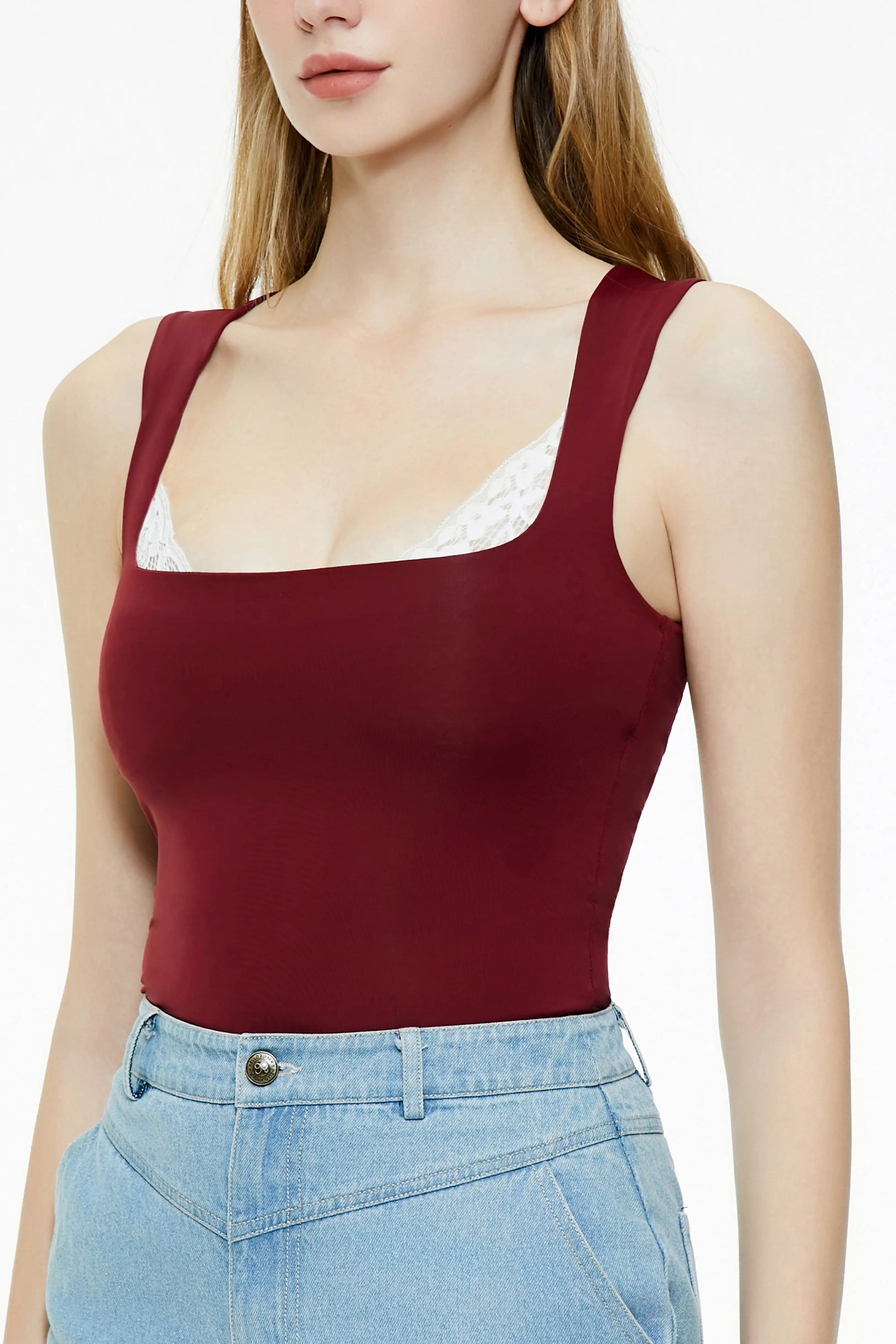 Close-up of a burgundy lace trim tank top with a square neckline