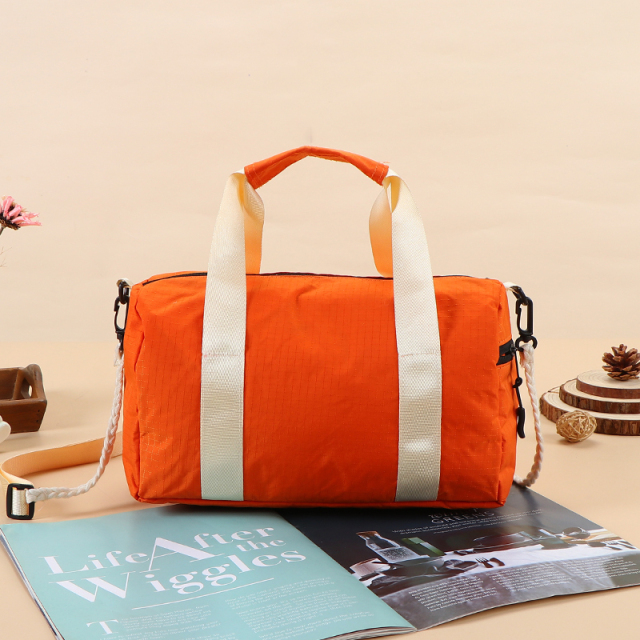 Travel Bag - Lightweight nylon gym bag  - Portable travel duffel  - Detachable shoulder strap bag  - Water-resistant sport tote  - Retro style barrel bag  - Casual crossbody duffel  - Small weekend travel bag