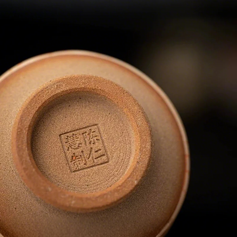 A profound moment of ritual as tea fills Eartivo "The Abstract Ascent"; the raw Rock-Mineral base meets the handcrafted gold icon, representing the “90% finished vessel”—completed by your presence and a smooth, tea-infused patina.