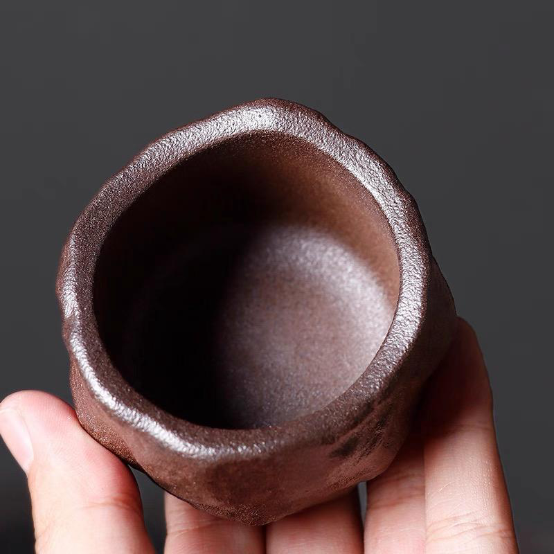 Top-down view of Eartivo "The Stone Sanctuary" cup, revealing the intimate curved rim and unrefined rock-mineral clay interior; this raw, desert-inspired surface is designed to naturally develop a smooth, tea-nourished patina through use.