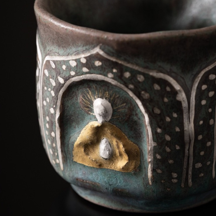 Close-up of Dunhuang-inspired mineral surface, where the raw "sand-worn" grit gradually softens into a smooth, tea-nourished patina, recording the passage of time.