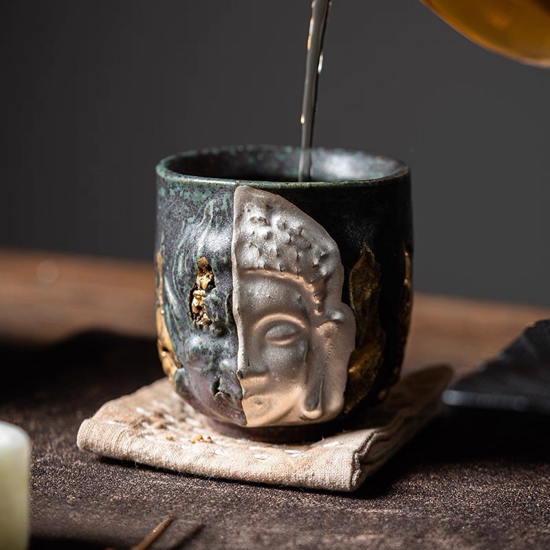A profound moment of ritual as tea fills Eartivo "The Duality Insight"; the raw Rock-Mineral base meets the handcrafted gold icon, representing the “90% finished vessel”—completed by your presence and a smooth, tea-infused patina.
