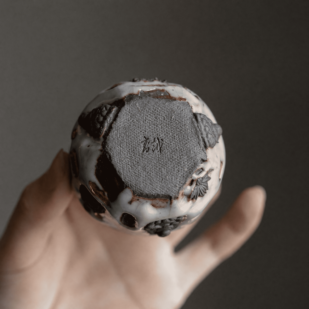 Bottom-up view of Eartivo "The Resilient Gold", featuring the artisan's signature maker's seal at the center.