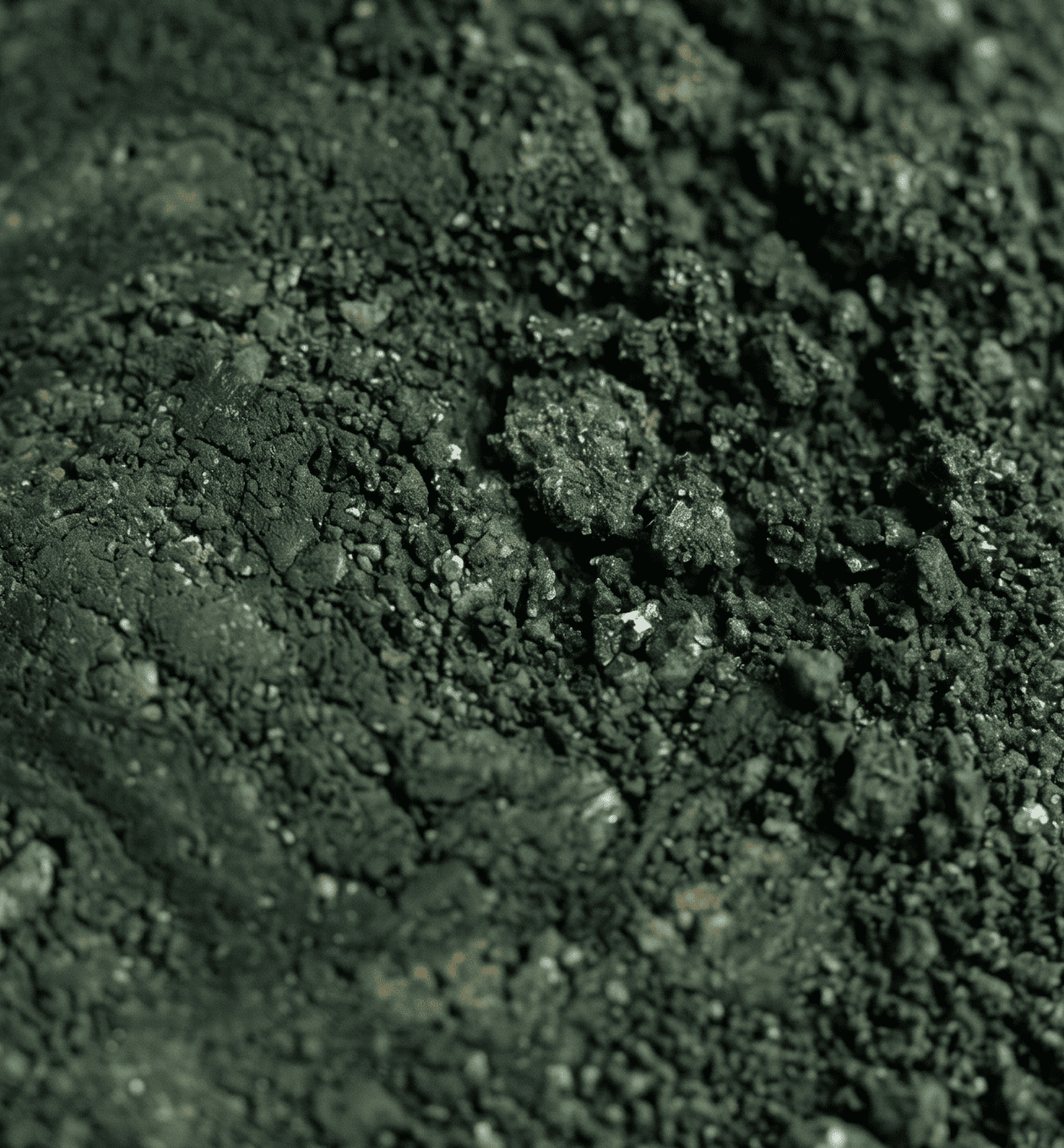 The Duality Insight handmade ceramic cup with dark green kiln transformation glaze &mdash; unpredictable glaze surface showing silver-white and deep black contrast from reduction firing ceramics