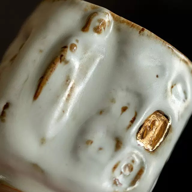 Detail of the hand-brushed Kohiki slip and a raised three-dimensional sacred saint figure on Eartivo “The Snow-Veiled Sanctuary”.