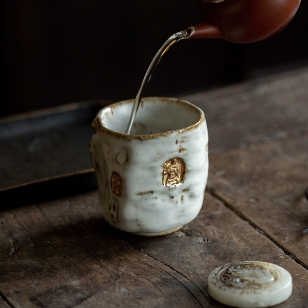 A profound moment of ritual as tea fills Eartivo "The Duality Insight"; the raw Rock-Mineral base meets the handcrafted gold icon, representing the “90% finished vessel”—completed by your presence and a smooth, tea-infused patina.
