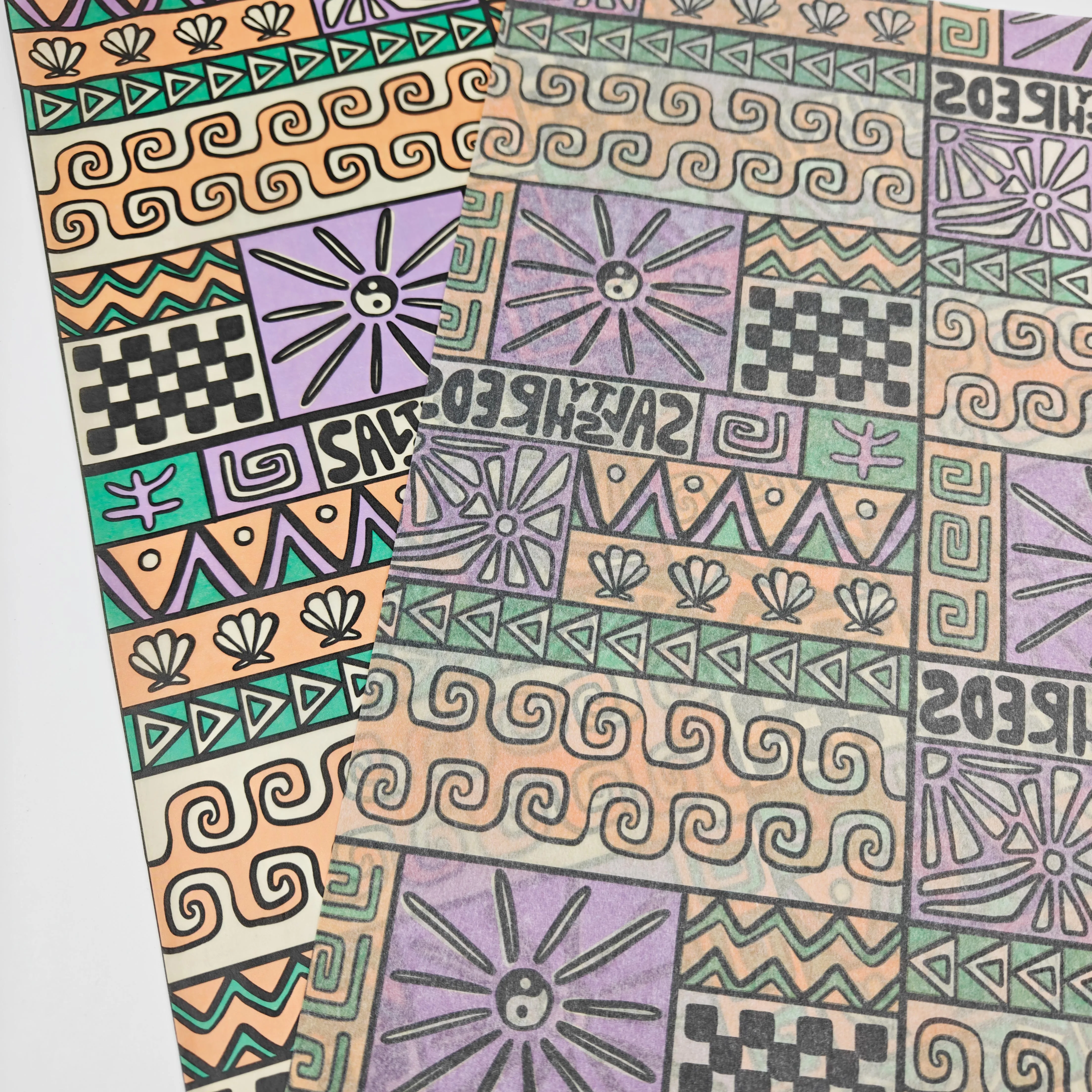Stacked custom printed tissue paper sheets showing consistent thickness and uniform logo print across a production run