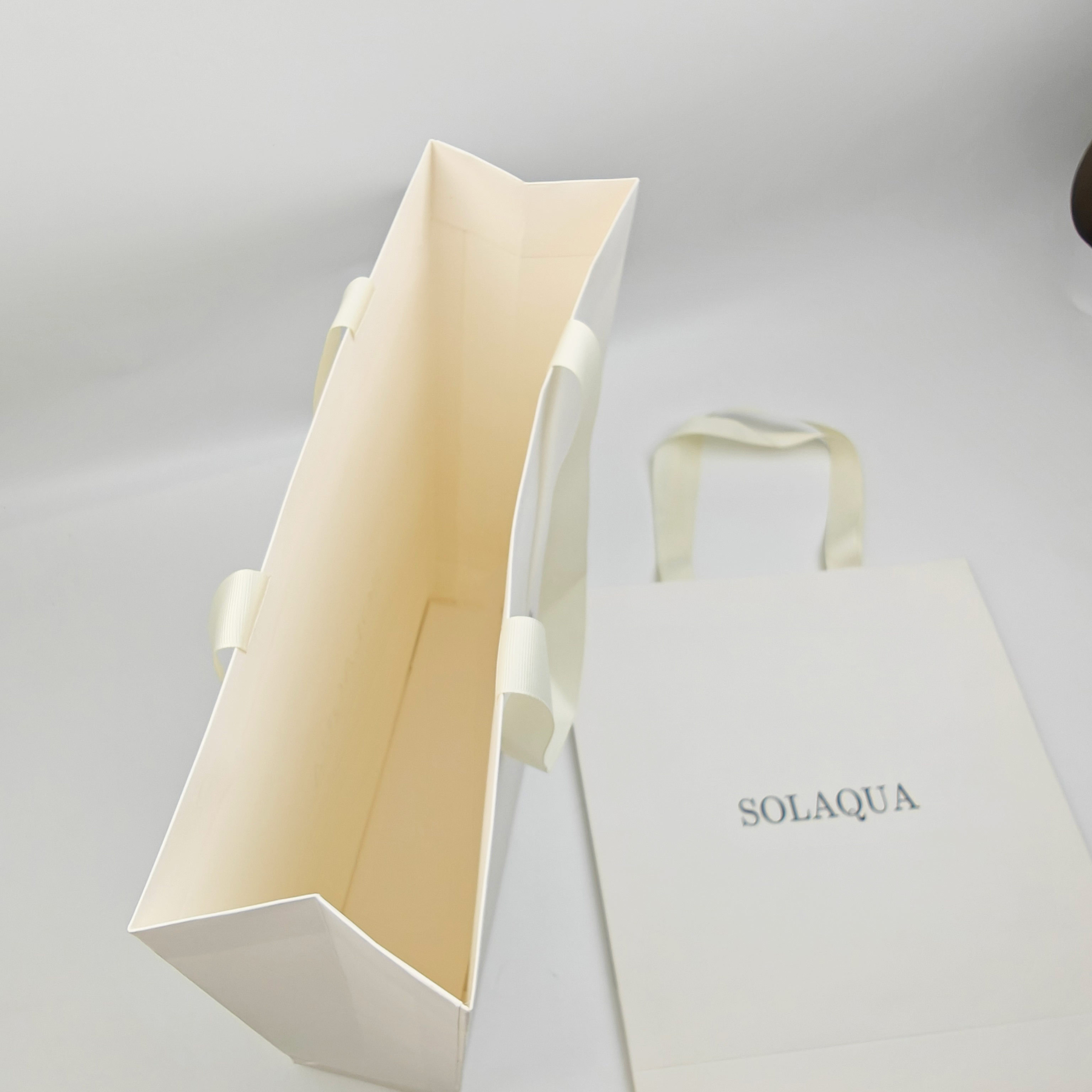 Custom White Kraft Gift Bags with Black Foil Logo & Ribbon Handles