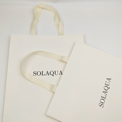 Custom White Kraft Gift Bags with Black Foil Logo & Ribbon Handles