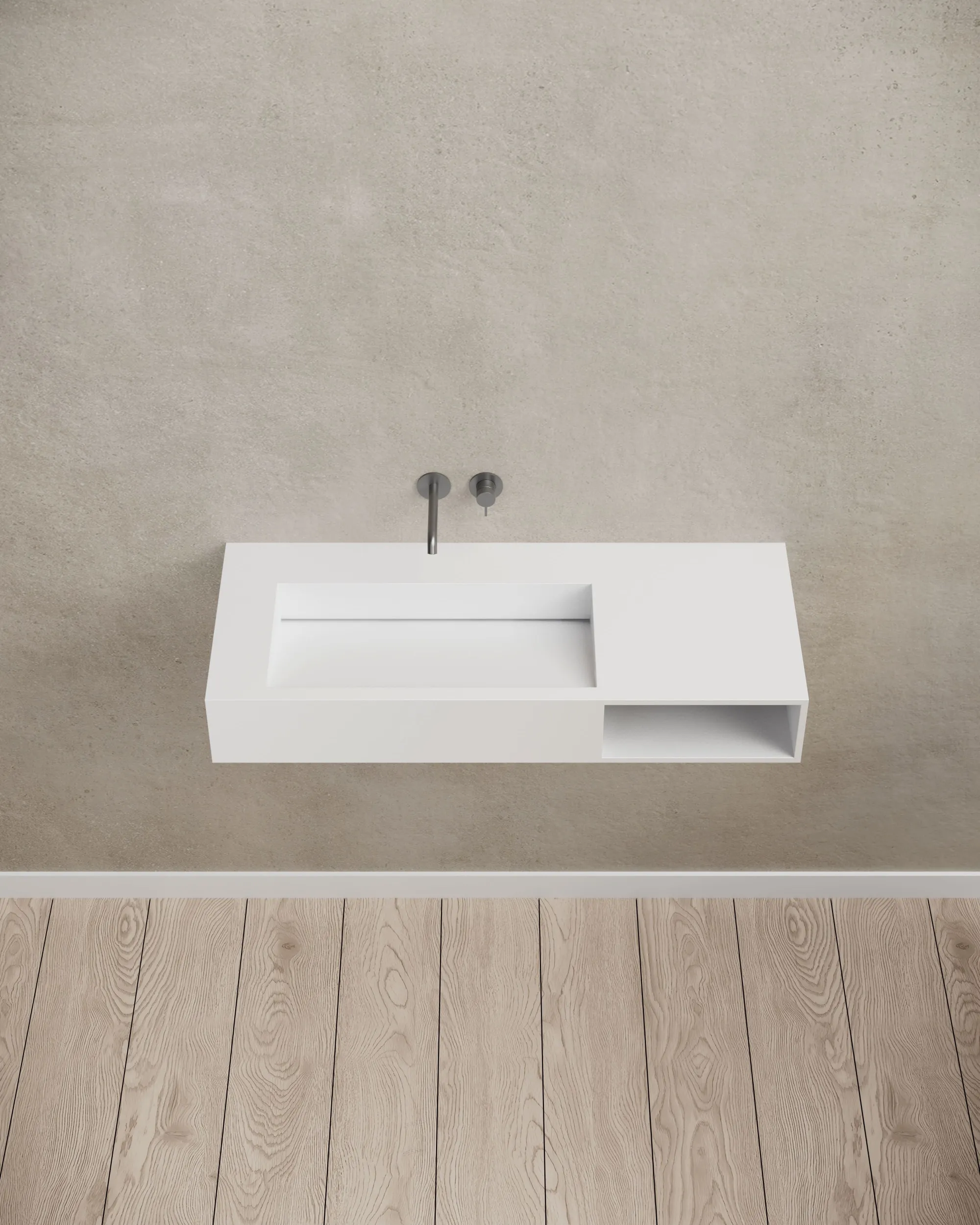 Modern wall-mounted solid surface basin installed in bathroom