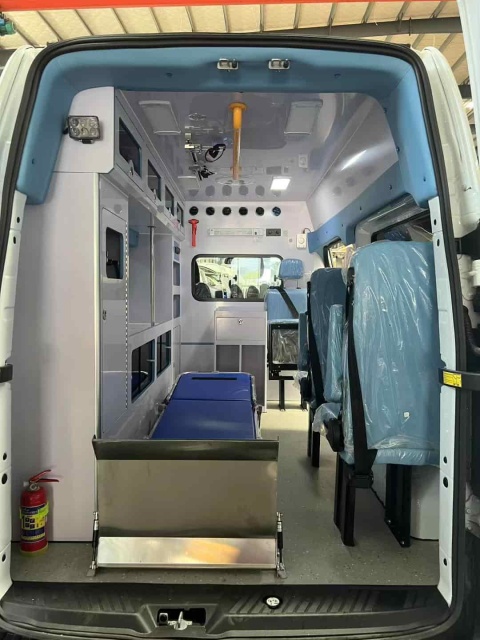 Ford National VI gasoline ambulance with raised bumper and long exhaust lights