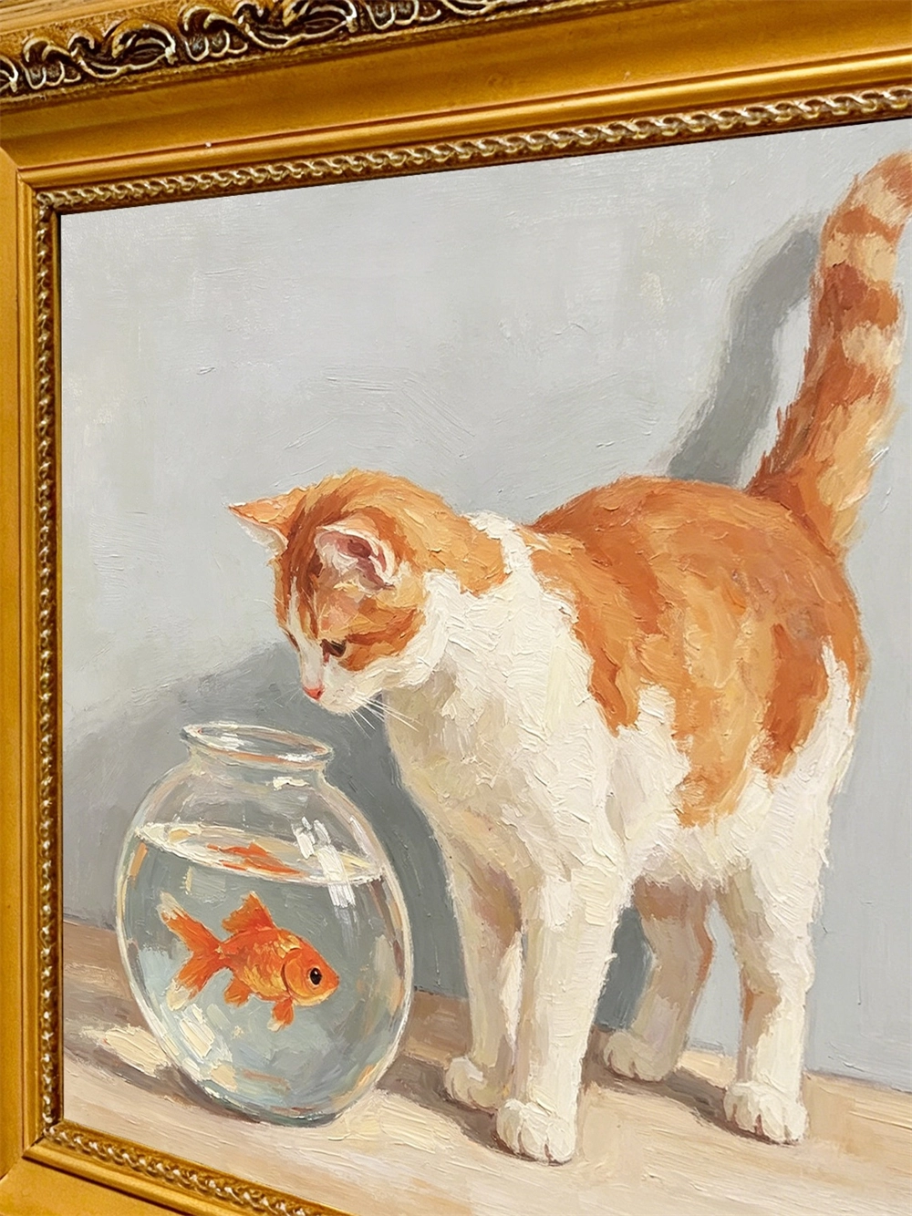Framed 4x4 inch cat and goldfish painting shown for scale next to household objects
