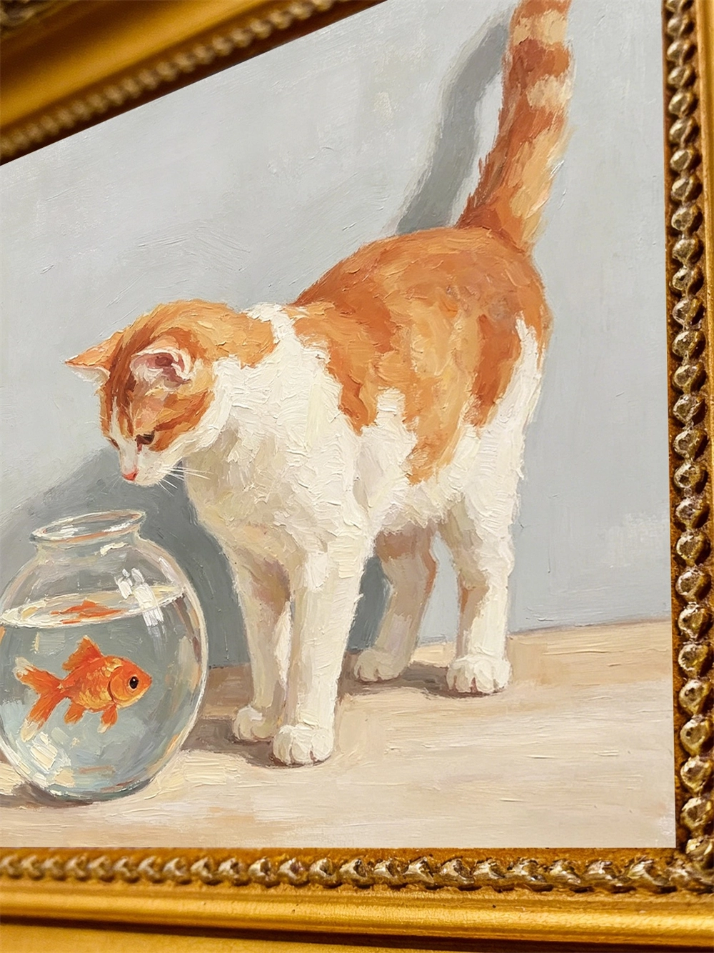 Close view of the 4x4 inch impasto cat and goldfish canvas inside its gold frame