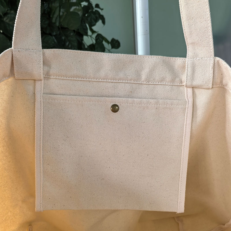 Canvas tote bag interior view with metal snap button inner pocket
