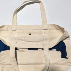 Canvas tote bag interior view with metal snap button inner pocket