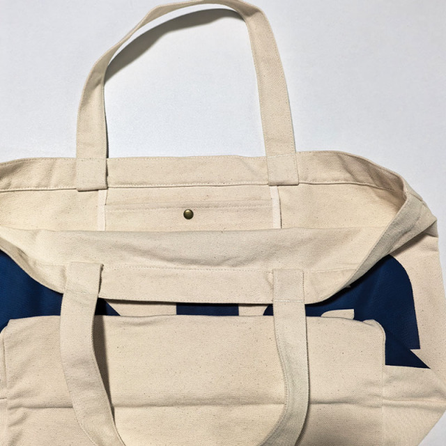 Canvas tote bag interior view with metal snap button inner pocket