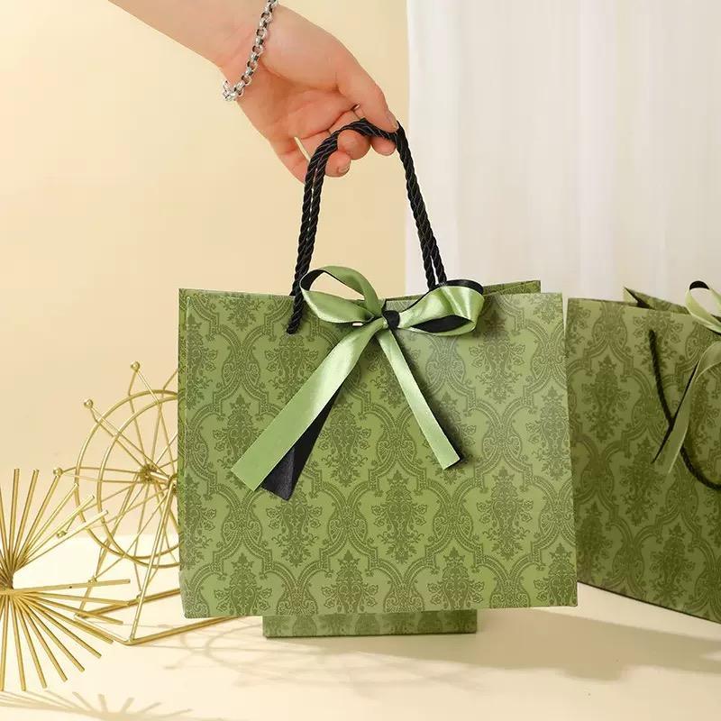 Vintage olive green patterned luxury gift paper bags with satin bow ribbon