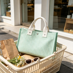 Striped canvas tote bag with snap‑button