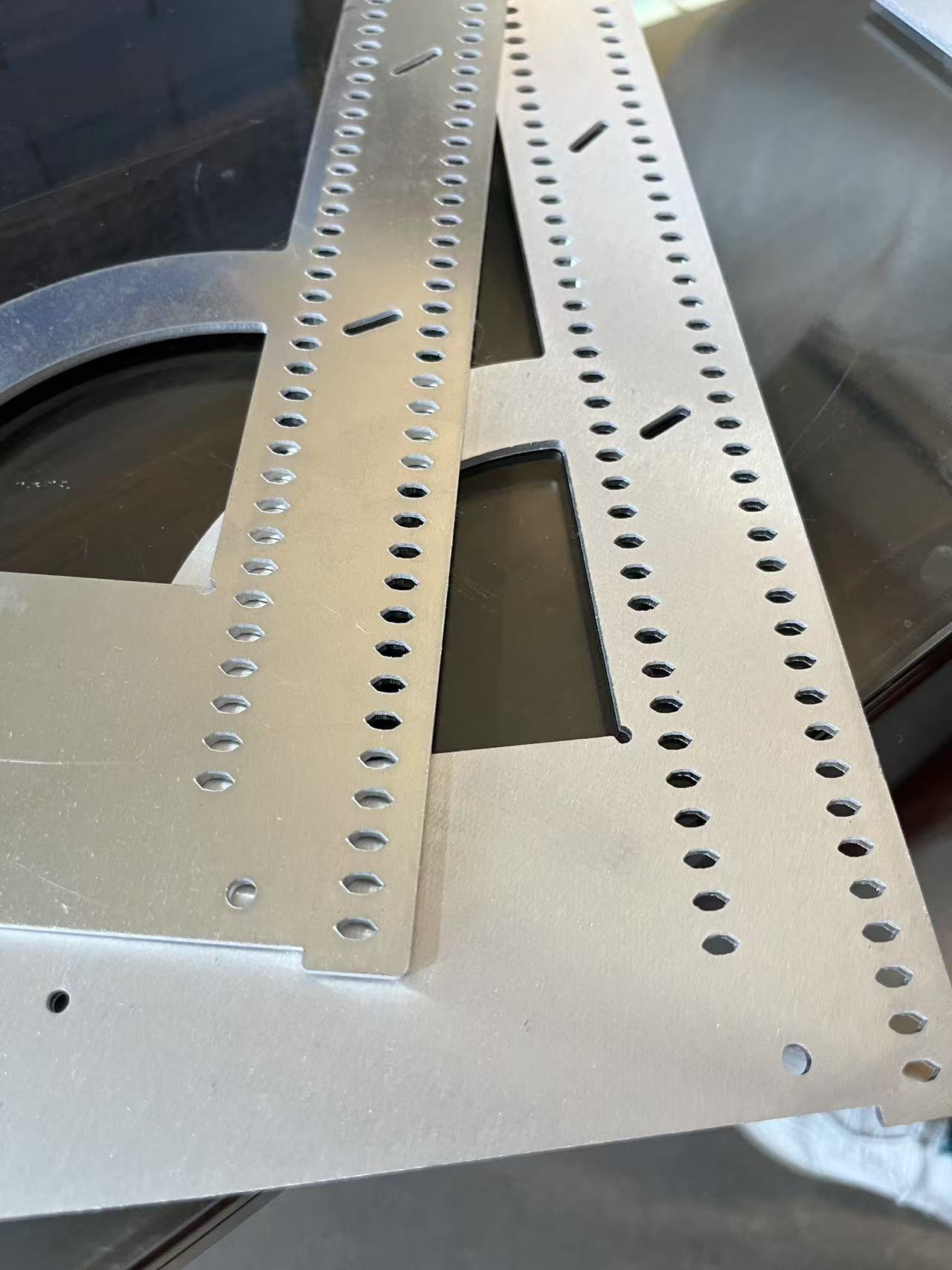 Confirmed aluminum sheet parts with holes, slots and cut edges